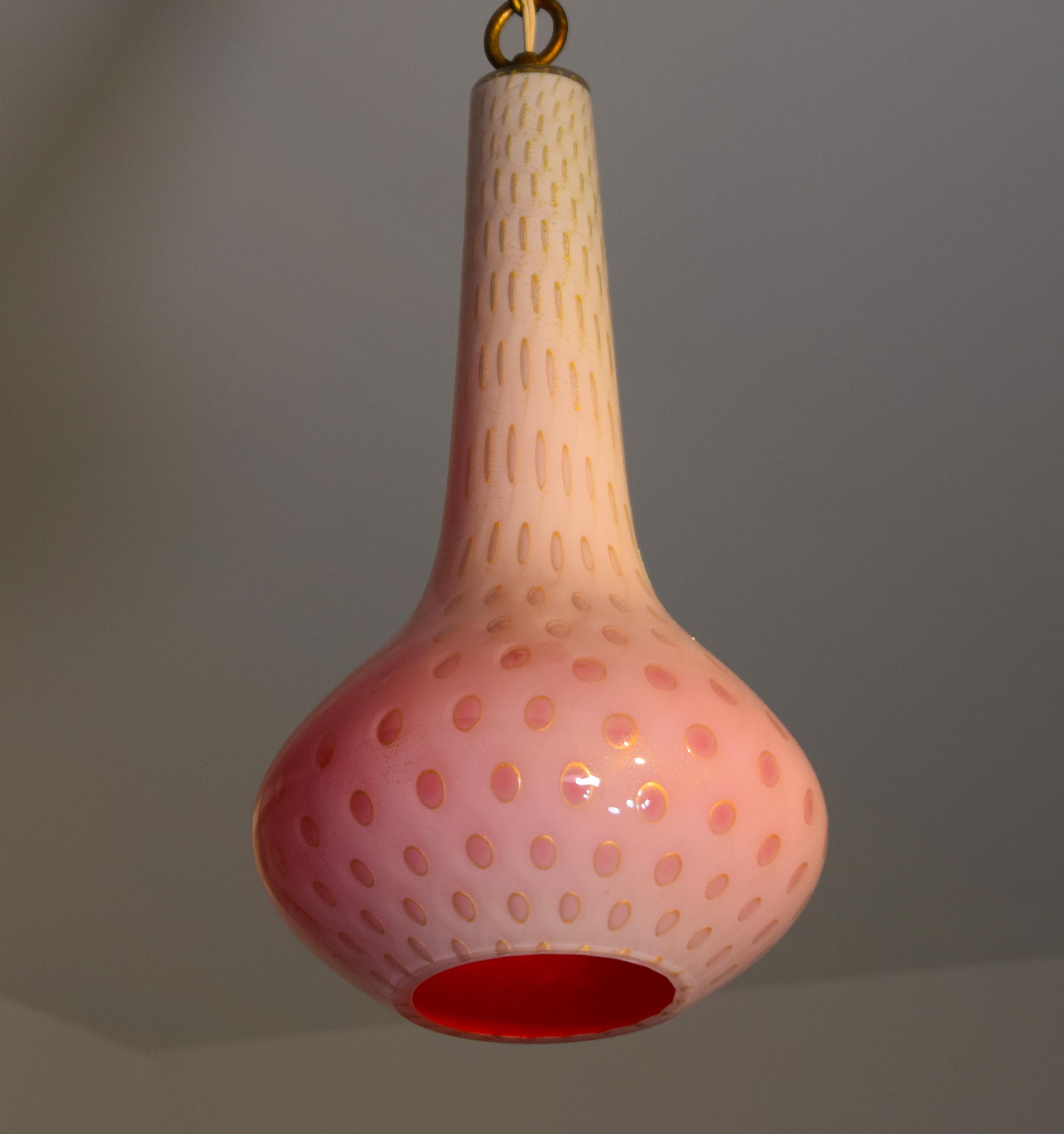 A rare pendant lamp by Aldrefo Barbini, Italy circa 1950. Cased genie glass with pink inside, and controlled bubbles in the outer glass with gold circles and flecks embedded in the white. Measures 23