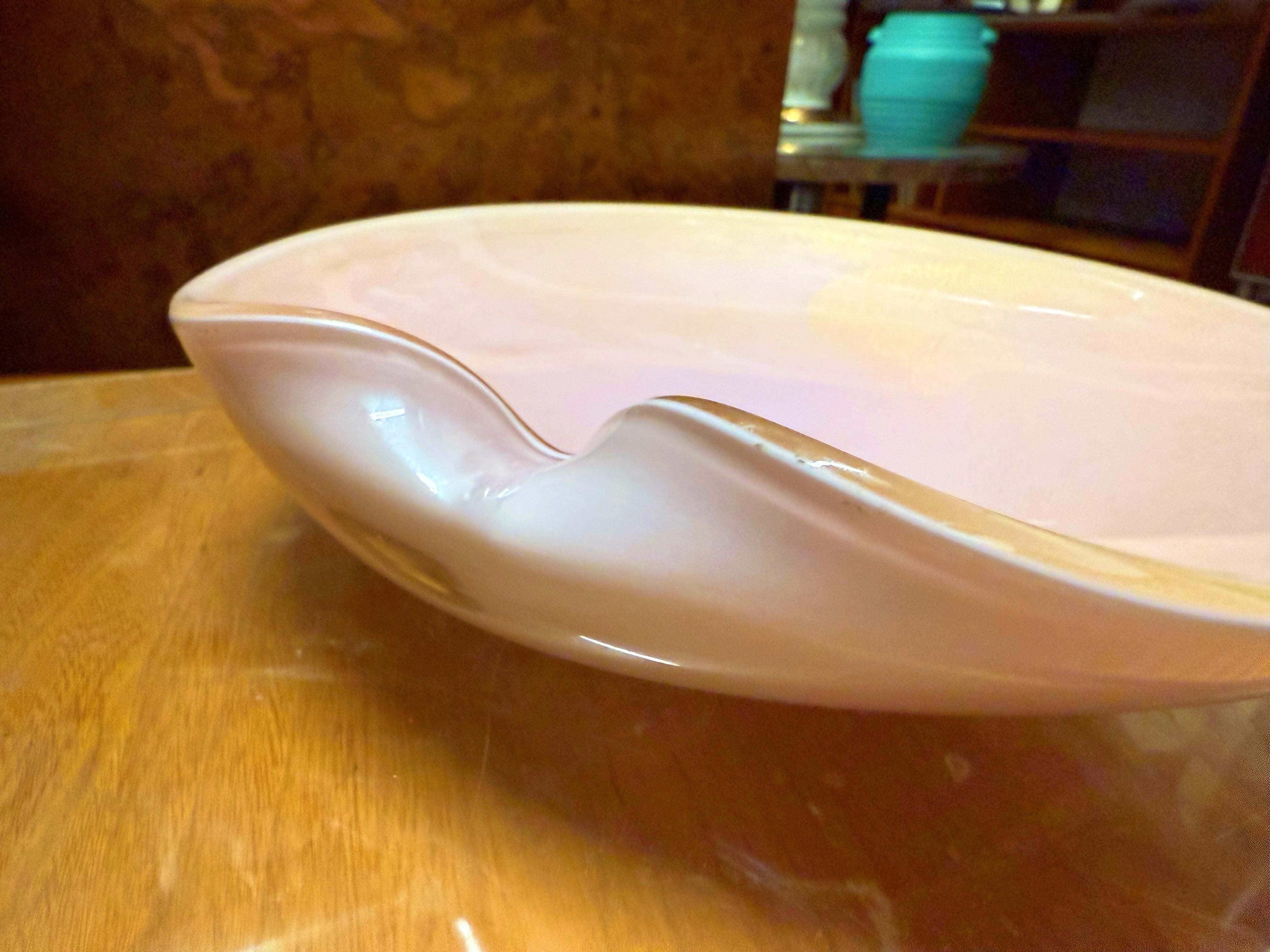 Complement any cocktail table, curved pink-colored glass with gold swirly dust that wraps around to the rim of the bowl, a lovely conversation started.  Alfredo Barbini, Italy, 1960’s