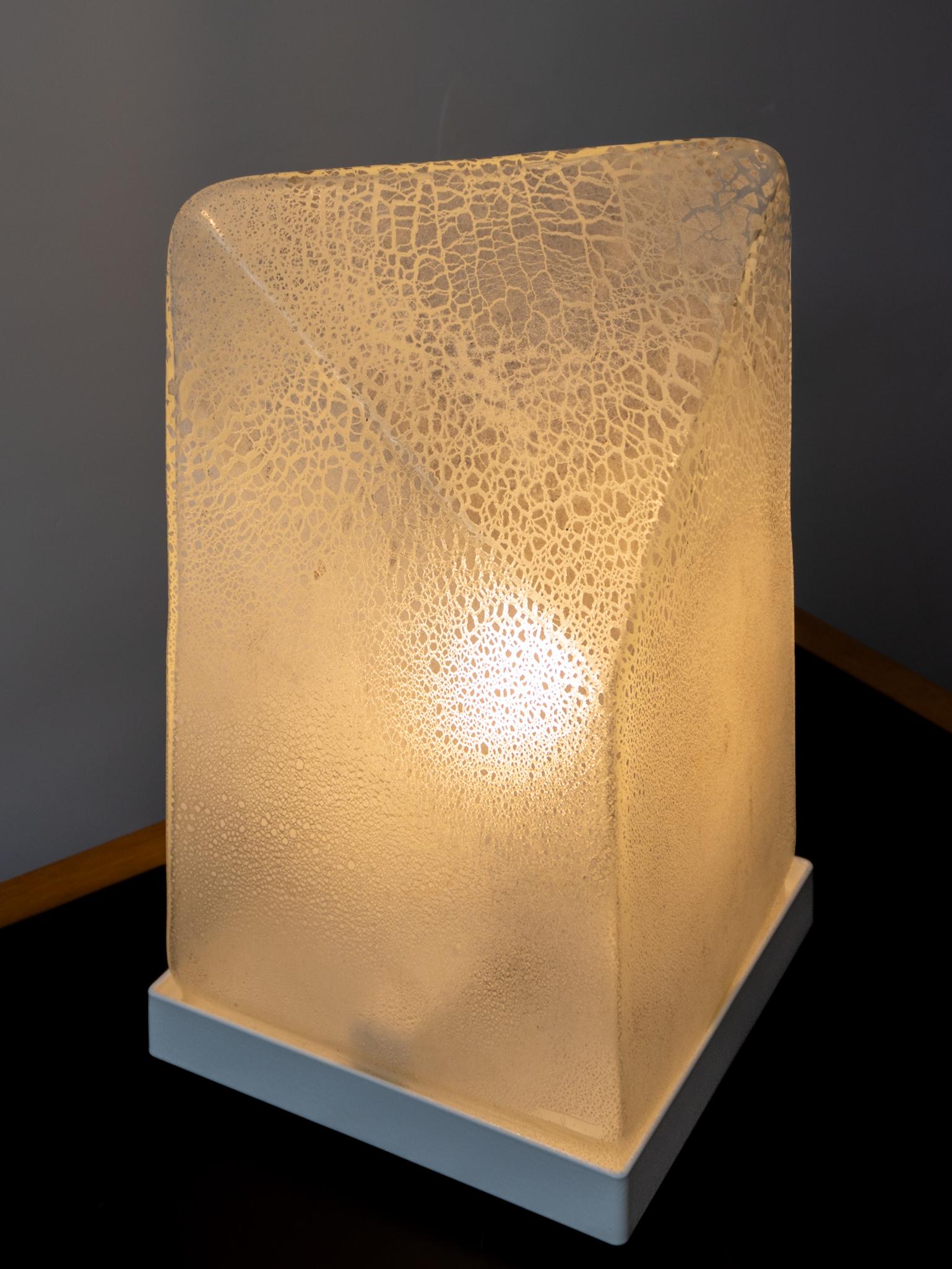 Belle lampe de table Murano scavo des années 70 avec un effet légèrement irisé soufflée à la bouche dans un moule préformé. Une pièce unique grâce à la technique du scavo, une création d'Alfredo Barbini.

Technique de Scavo consistant à appliquer, à