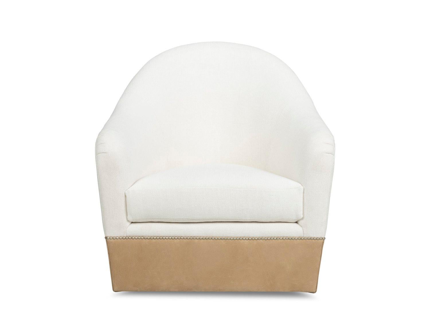 Generously scaled barrel chair whose fluid silhouette incorporates a higher back and a distinctive band of leather wrapping around the lower part of the form giving it a masculine modern edge.

- Swivel Base Standard
- Nail Heads Available
-