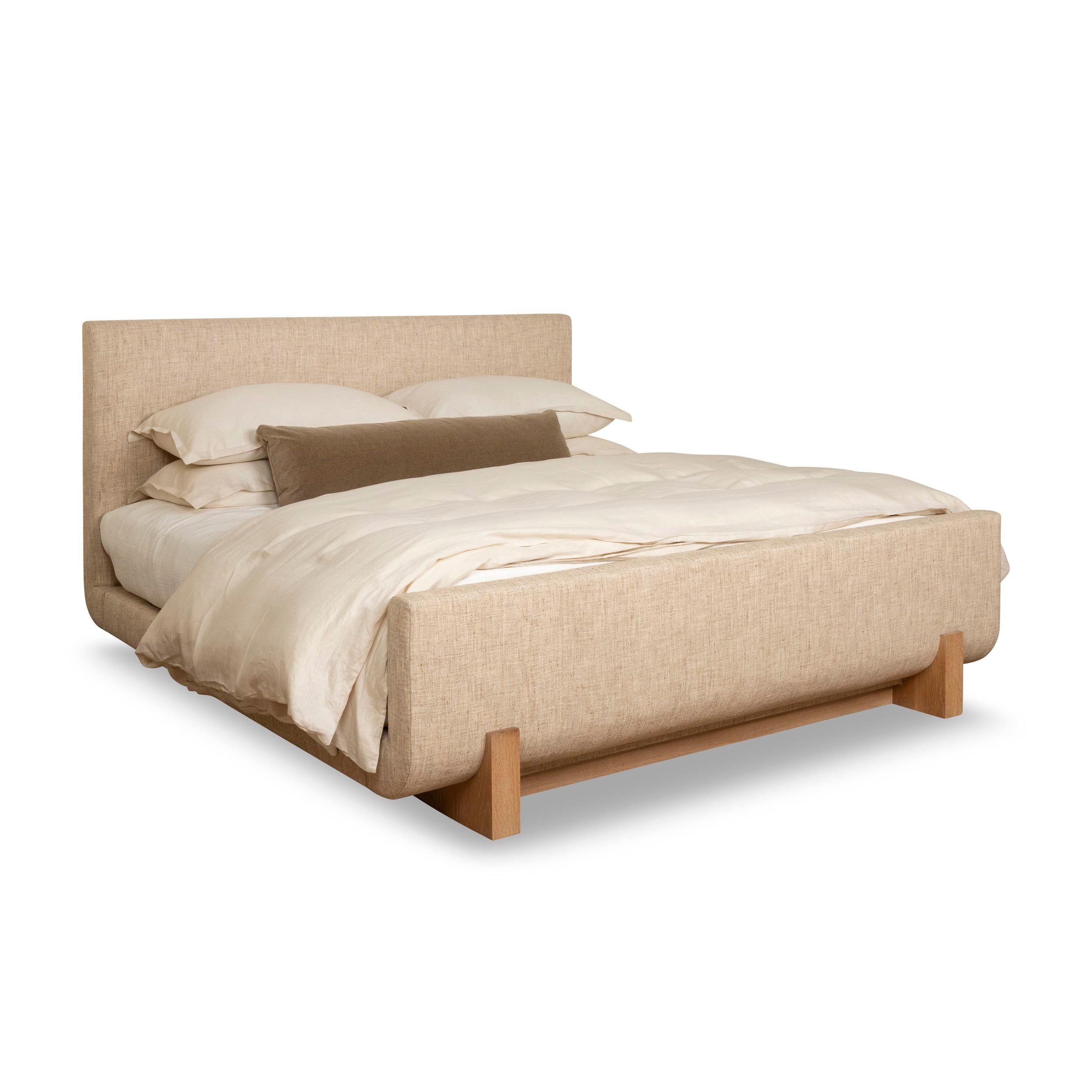 A contemporary sleigh bed with a sleek low profile. Radiused corner planes of soft upholstery rest on a distinctive oak sled base. The overhanging sides enable one to to walk around the bed comfortably.

- Oak Base
- Platform
- Available in all
