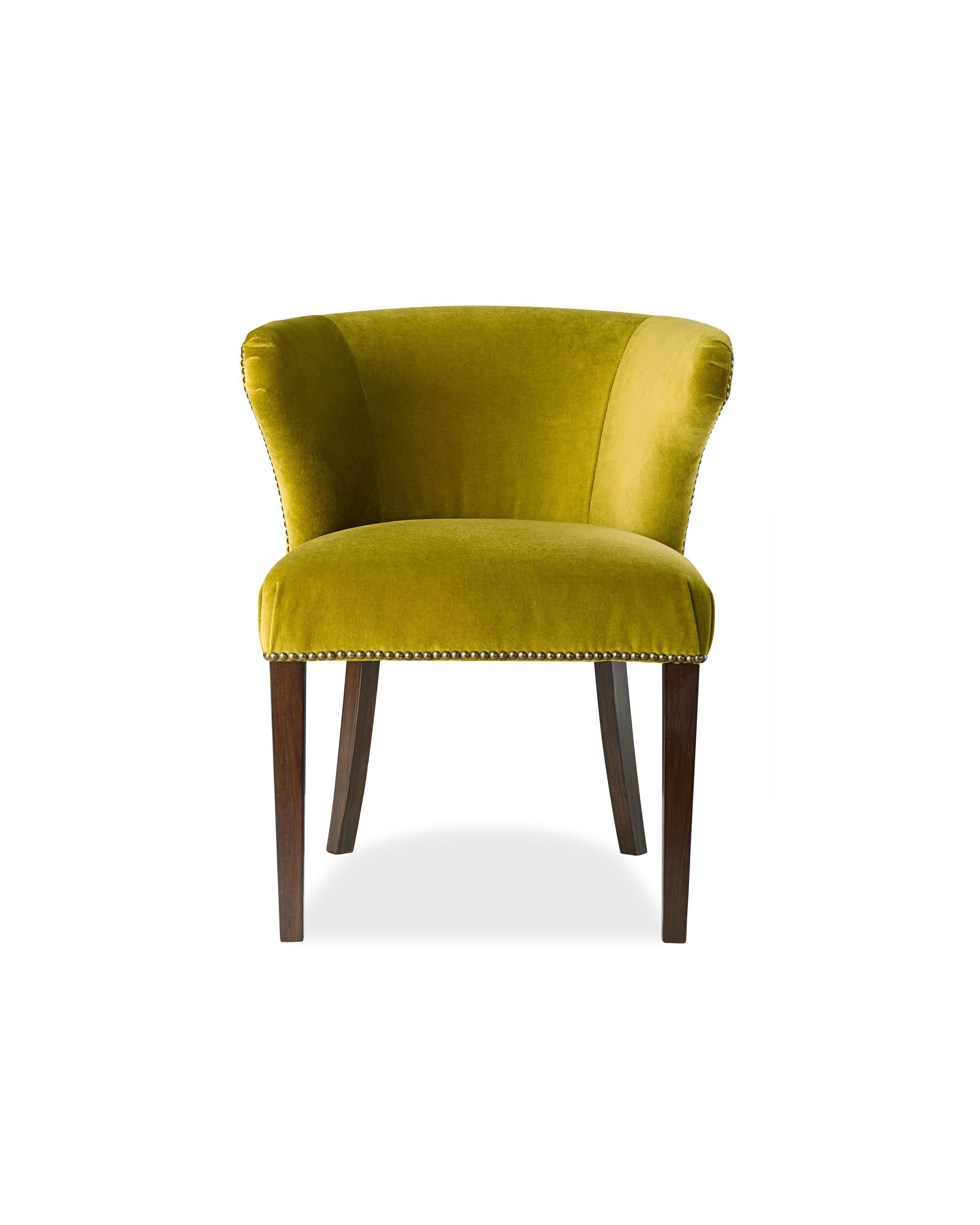 An unusual  3/4 barrel back dining chair which provides great comfort with elegantly detailed upholstery and a fluid shape that works in traditional and contemporary environments. Such lower dining chair backs make a room feel more spacious too.