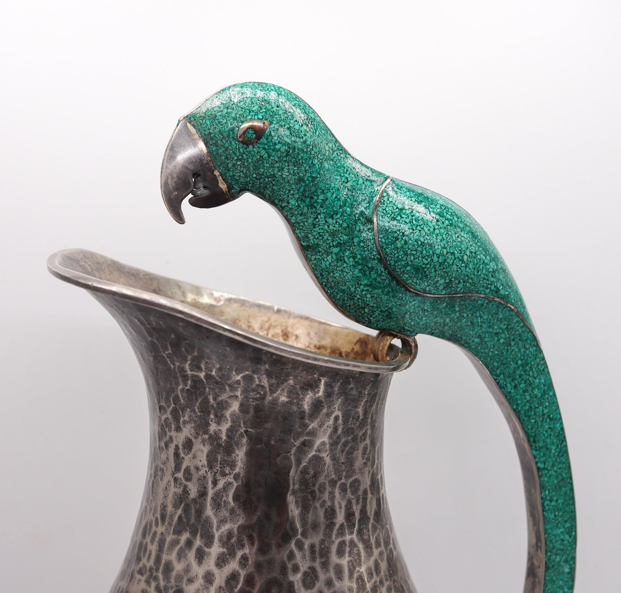 A parrot pitcher designed by Alfredo Villasana.

This is a very decorative hammered pitcher created in the city of Taxco Mexico at the silversmith atelier of Alfredo Villasana. A vintage piece boasting original patina and exquisite craftsmanship