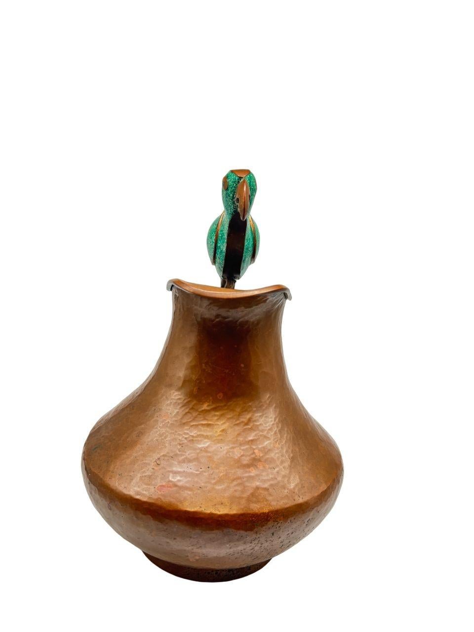 Introducing the Alfredo Villasana Taxco Parrot Pitcher: a vintage piece boasting original patina and exquisite copper craftsmanship from Mexico. This unique pitcher showcases the artistry of Alfredo Villasana and reflects the rich cultural heritage