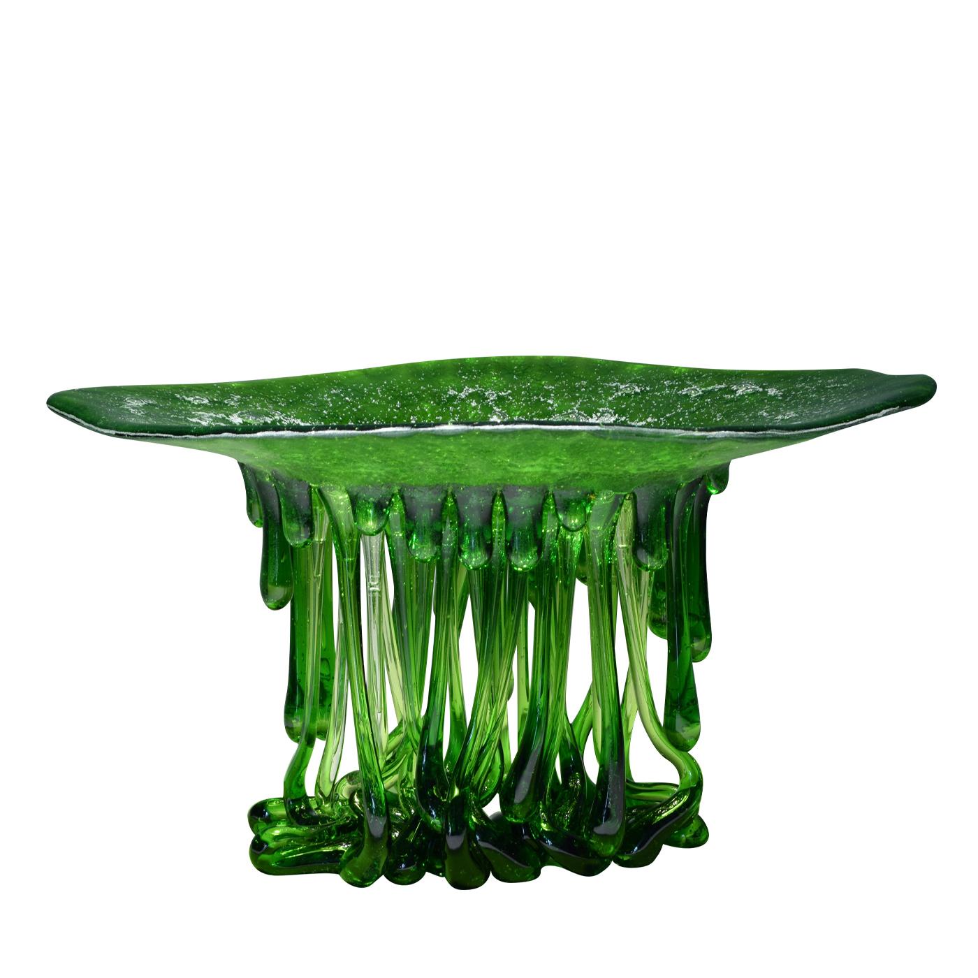 This beautiful green sculpture made from Murano glass creates a pool of color on surfaces on which it rests thanks to light filtering through the glass. The shape of this piece conjures up jellyfish in the mind, as the sculpture has a flower-shaped