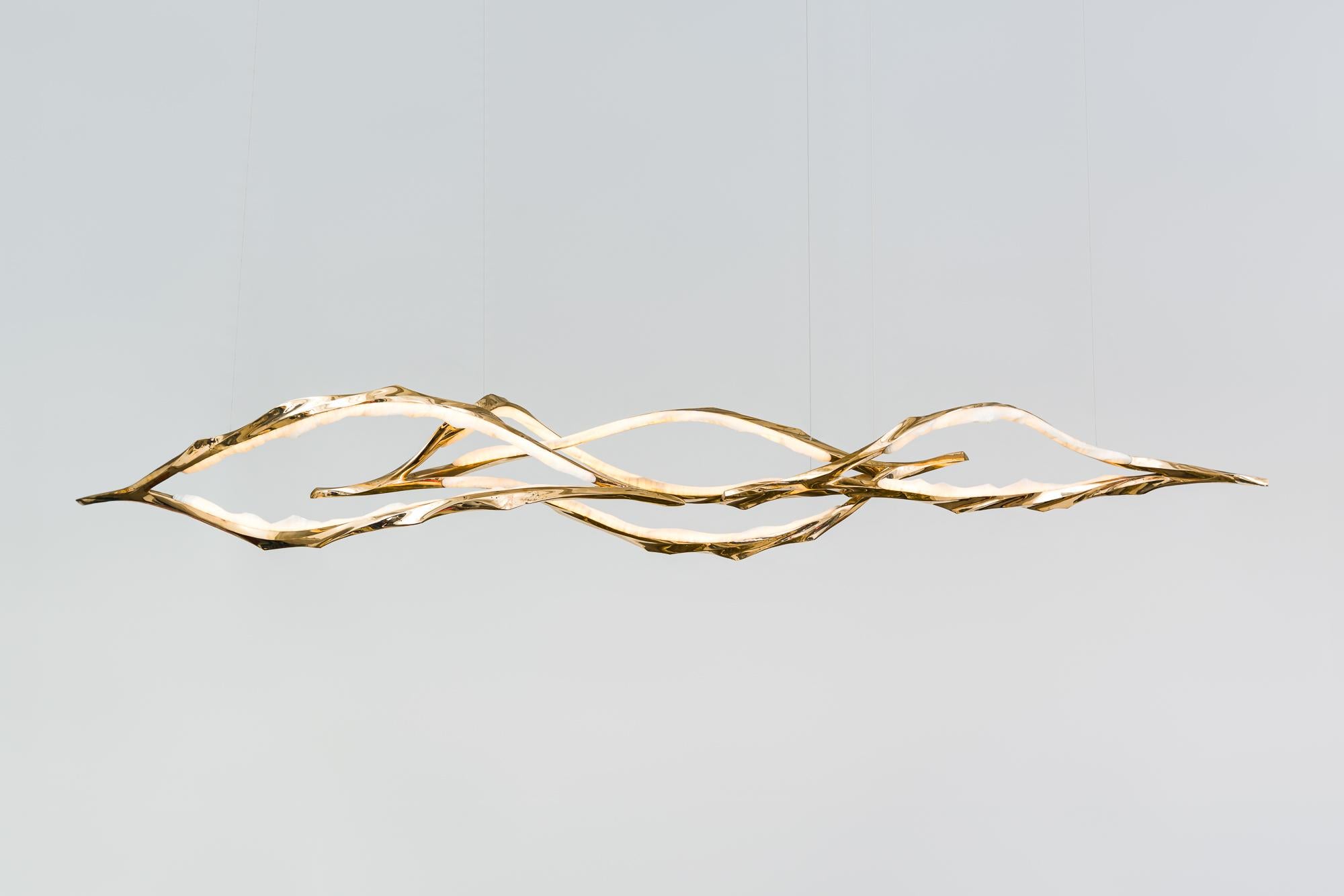 Composed of a series of tiered, interconnected bronze and onyx ribbons, Markus Haase’s new series of lighting, the Algae Series, creates a sweeping landscape of radiant, sculpted light. Combining a mastery of traditional sculpting techniques with a