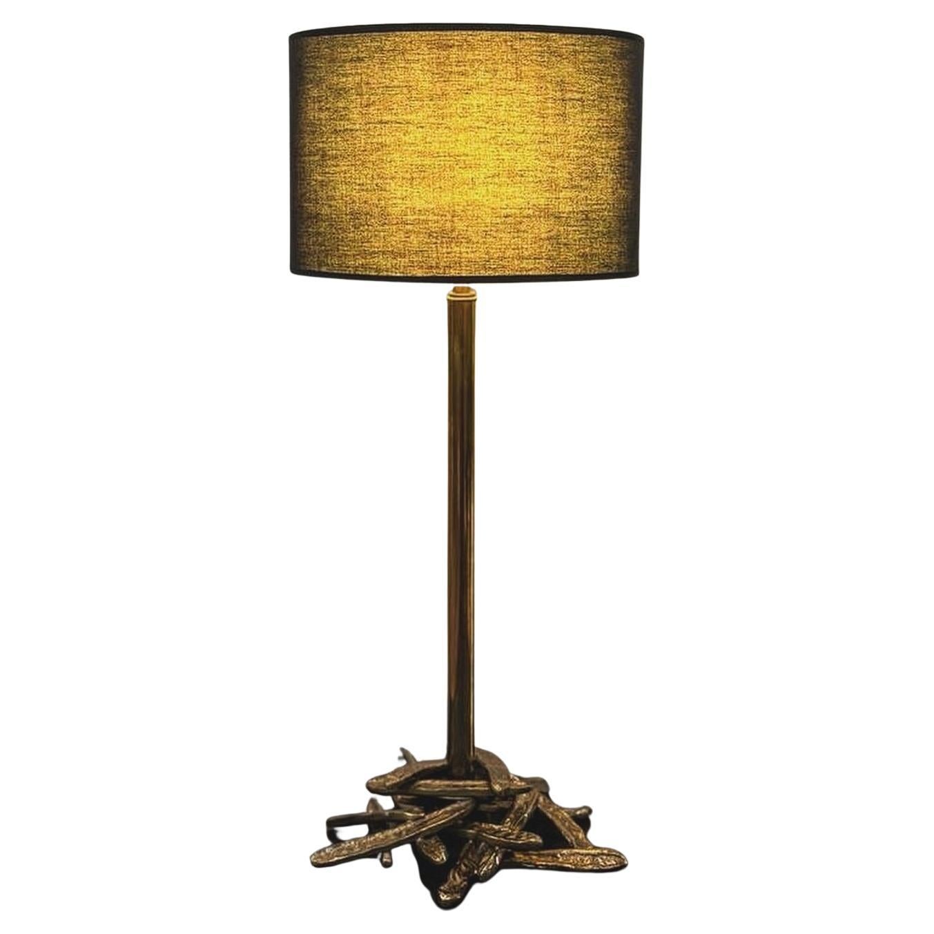 ALGAROBBA Table Lamp, a testament to the seamless fusion of nature-inspired design and contemporary elegance. Crafted from brass pipe, this exquisite table lamp boasts a unique structure that holds a fabric shade, creating a harmonious blend of