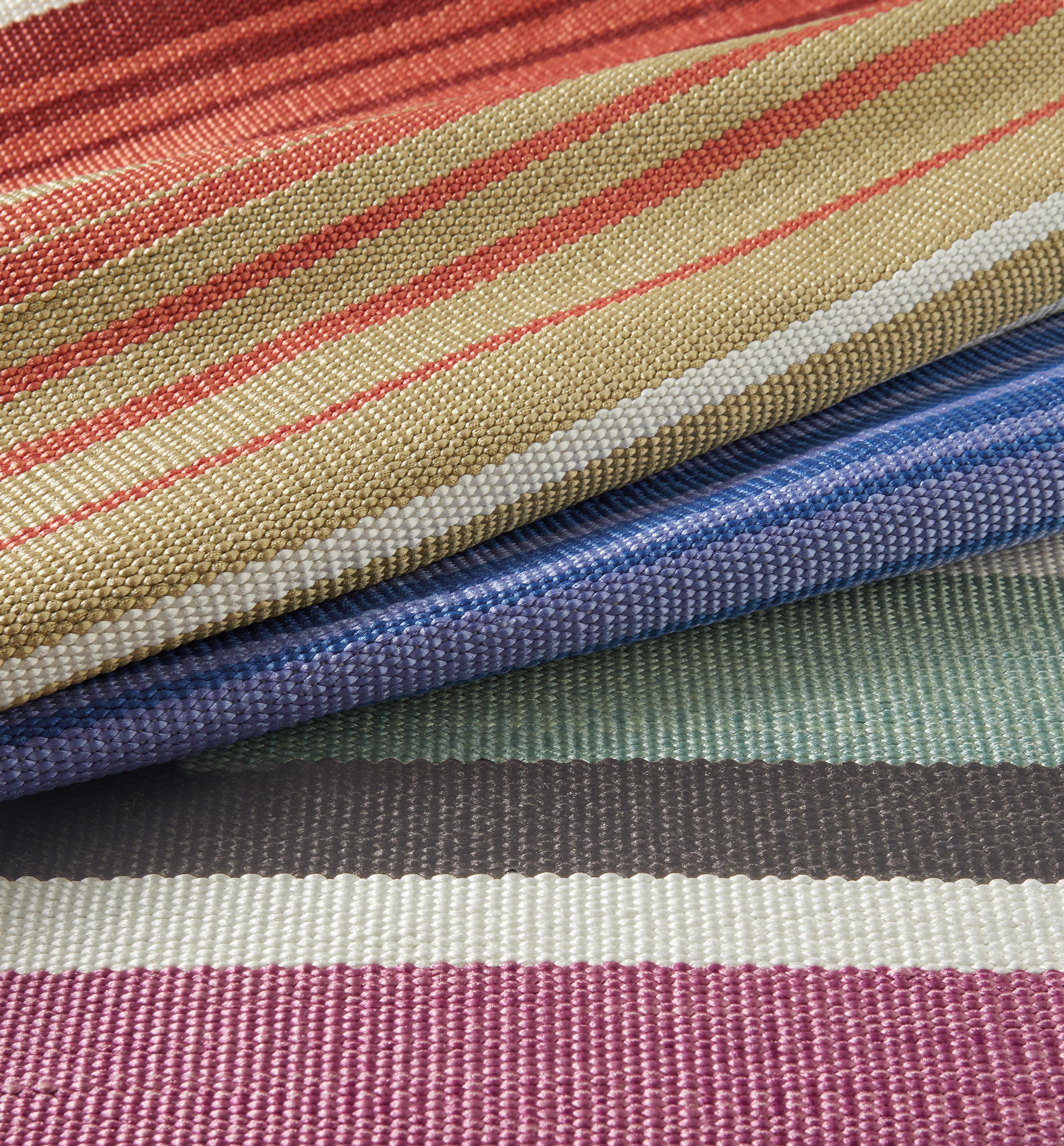 Missoni Home's outdoor multi-colored striped rug; made to withstand outdoor elements
   