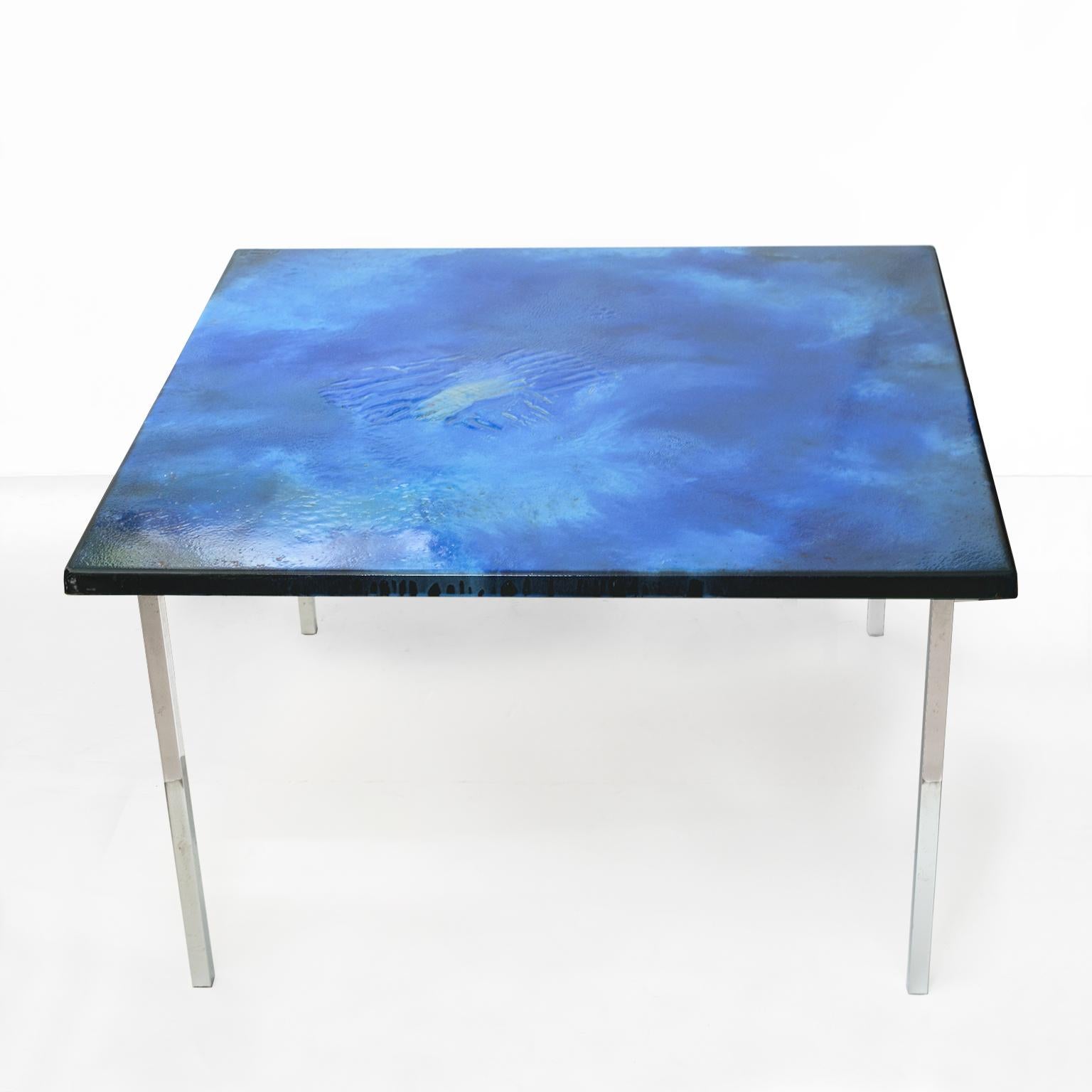 A vibrant blue enamel on copper Scandinavian Modern coffee table with chromed steel legs. The table was designed by Algot Törneman and produced for NK (Nordiska Kompaniet) in Nykoping, Sweden. Light wear to legs.

Signed by the artist and numbered