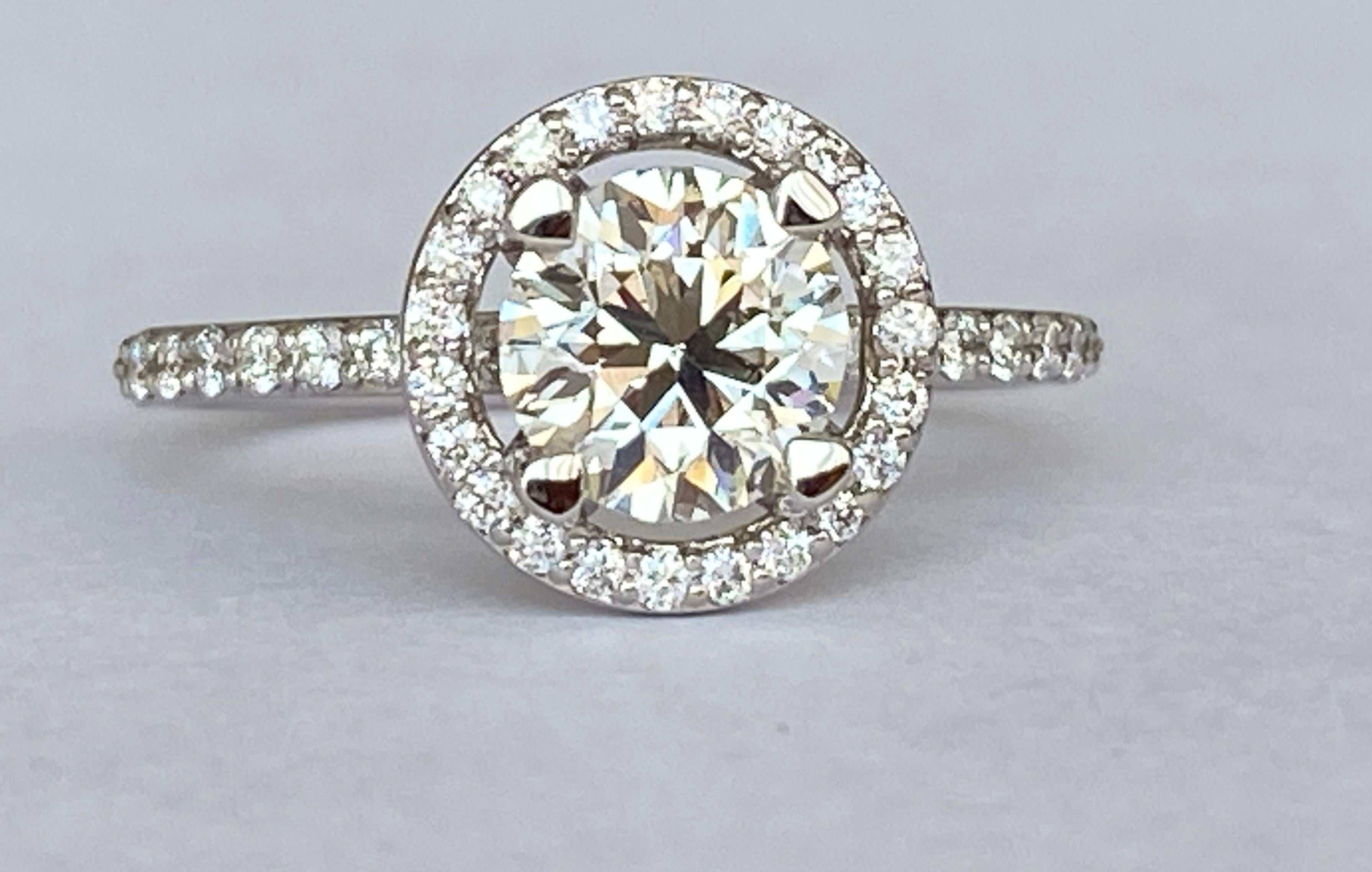 Solitaire ring in 18 kt white gold with a brilliant cut diamond of 1.08ct quality K/VS1 and 37 brilliant cut diamonds of approx 0.28 ct in total,F/ G/VS.
Grade: 18 kt (marked 750) 
Weight: 3.16 gram 
Ring Size: 17.50 mm /7 USA size
Comes in a ring