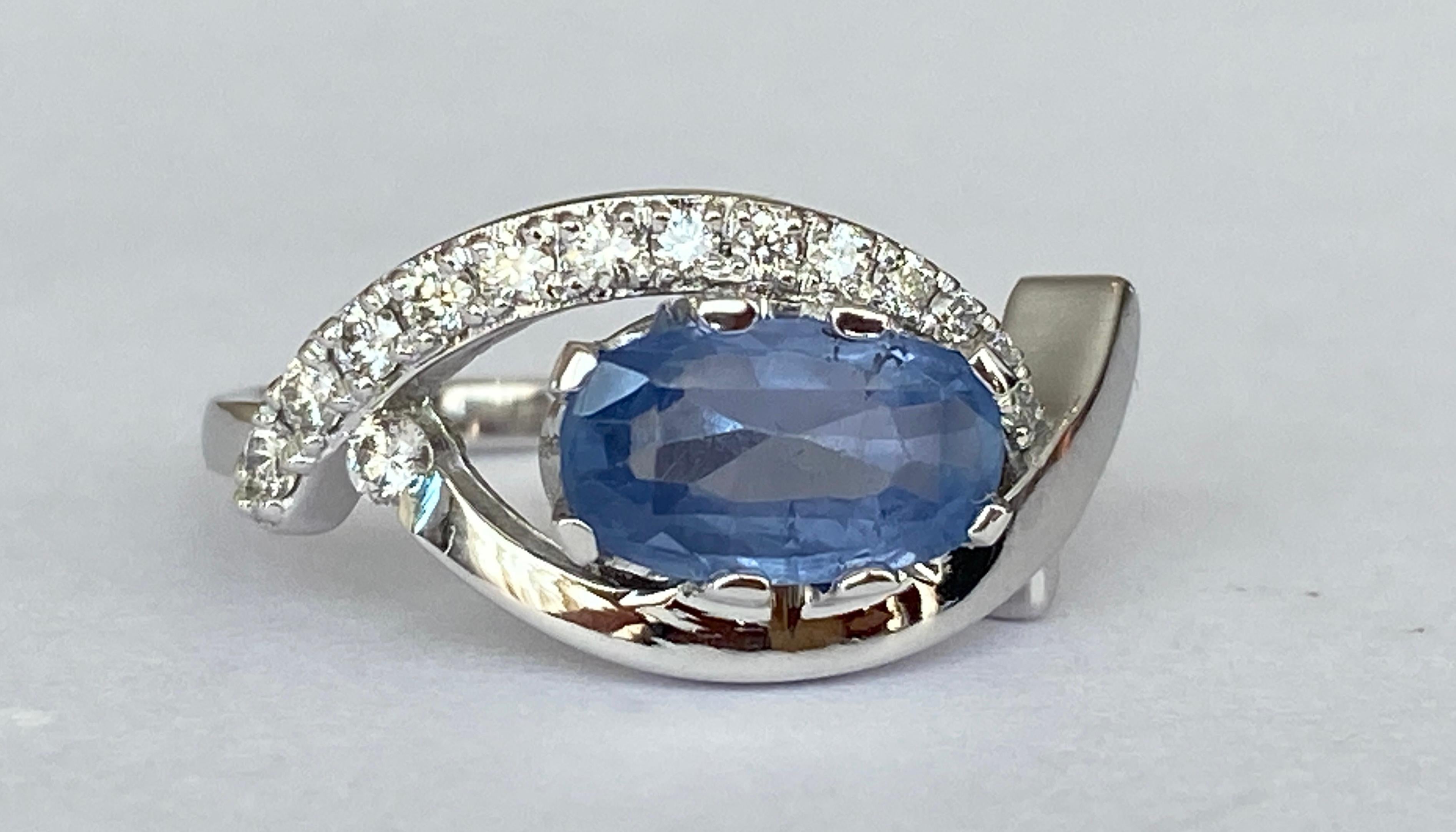 Exclusive  ring in 18 kt white gold set with oval mixed cut sapphire of 1.85 carats and decorated with 14 pieces of brilliant cut diamonds. Total diamonds:0.25 ct F/G/VS/SI. ALGT certificate for the main stone is included. Number 64460786. 
Gold