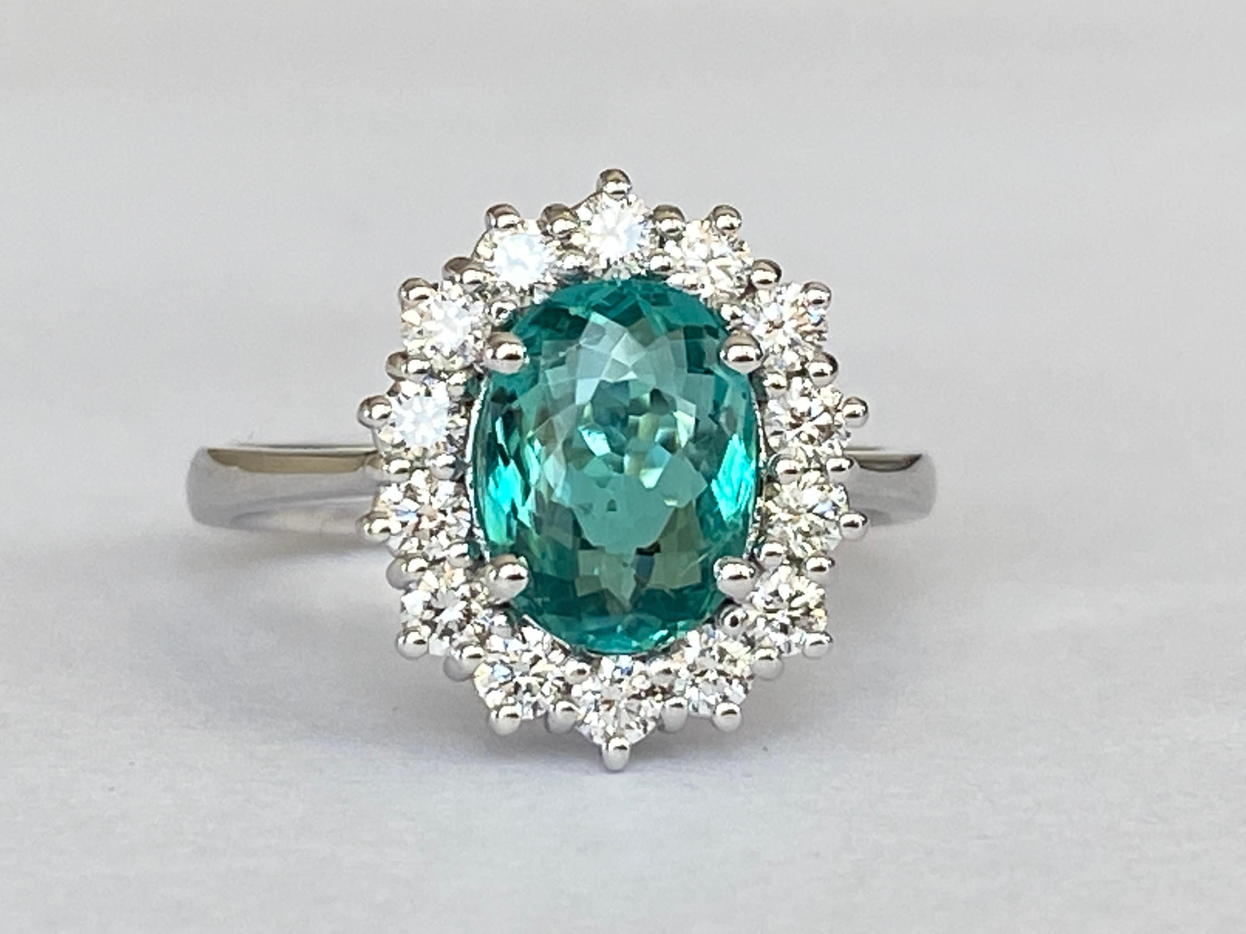 Exclusive handmade ring in 18 kt white gold set with oval mixed cut paraiba tourmaline of 1.59 carats and decorated with 14 pieces of brilliant cut diamonds. Total diamonds:0.48 ct F/G/VS/SI. ALGT certificate is included. Number 51387709. The