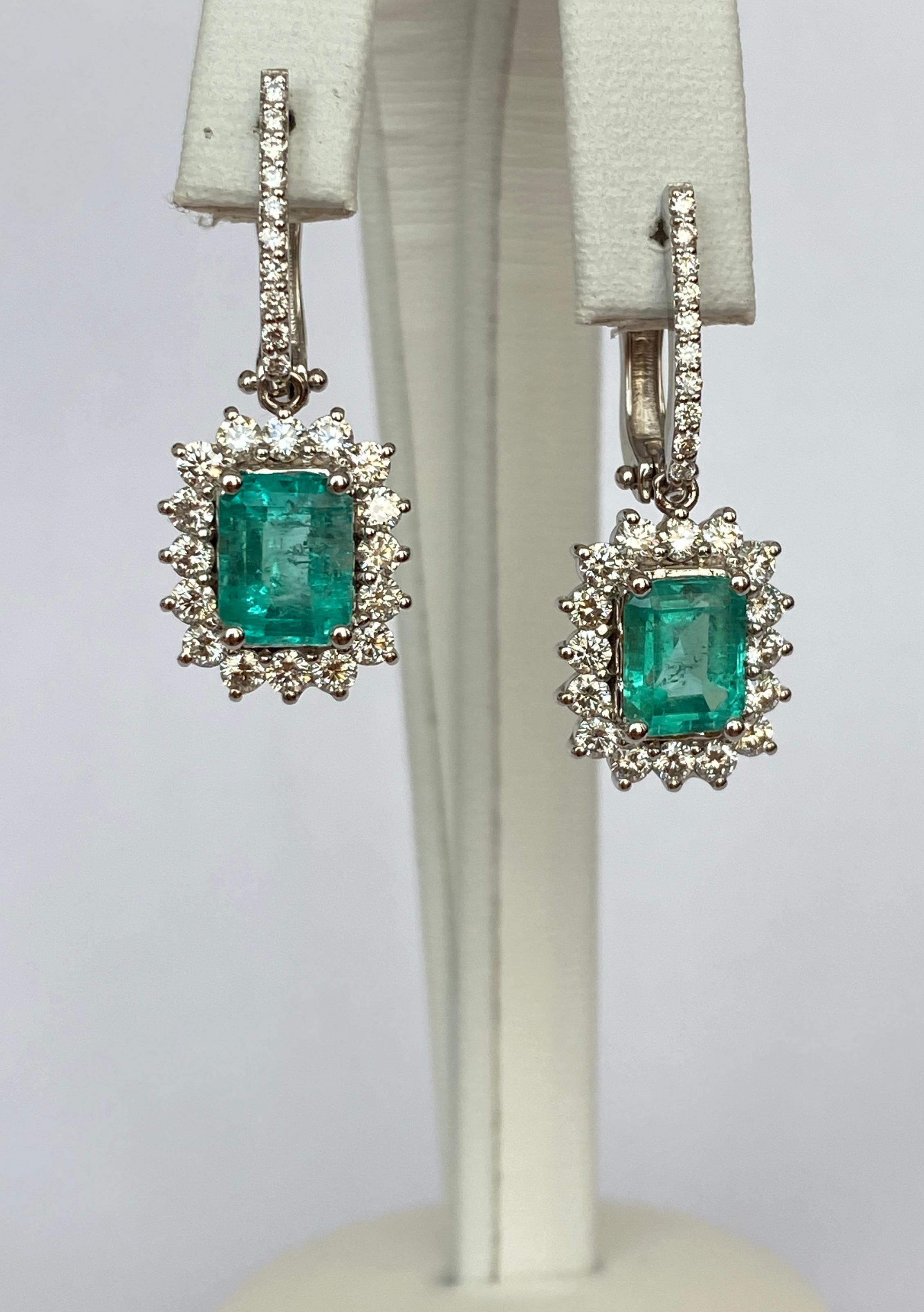 Offered in new condition, beautiful earrings in white gold, set with 2 pieces of emerald cut emerald 2.55 ct, which are decorated with 52 pieces of brilliant cut diamonds together approx. 1.24 ct of quality F-G/VS. ALGT certificate is included. The