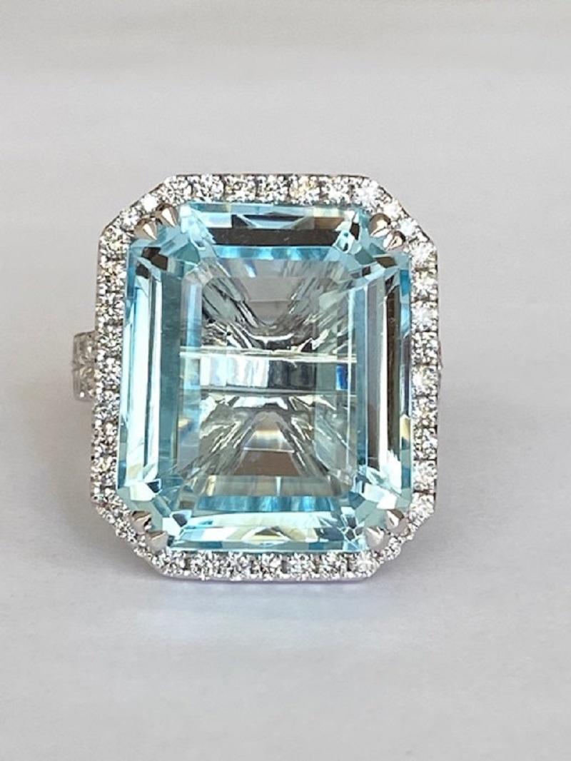  Exclusive 18 kt white gold ring set with emerald cut aquamarine of approx. 18.00 ct! And decorated with 74 brilliant cut diamonds. Total number of diamonds: 1.10 ct E/F/VVS/VS ALGT certificate is included.  Gold grade: 18 kt (marked). 1 emerald cut