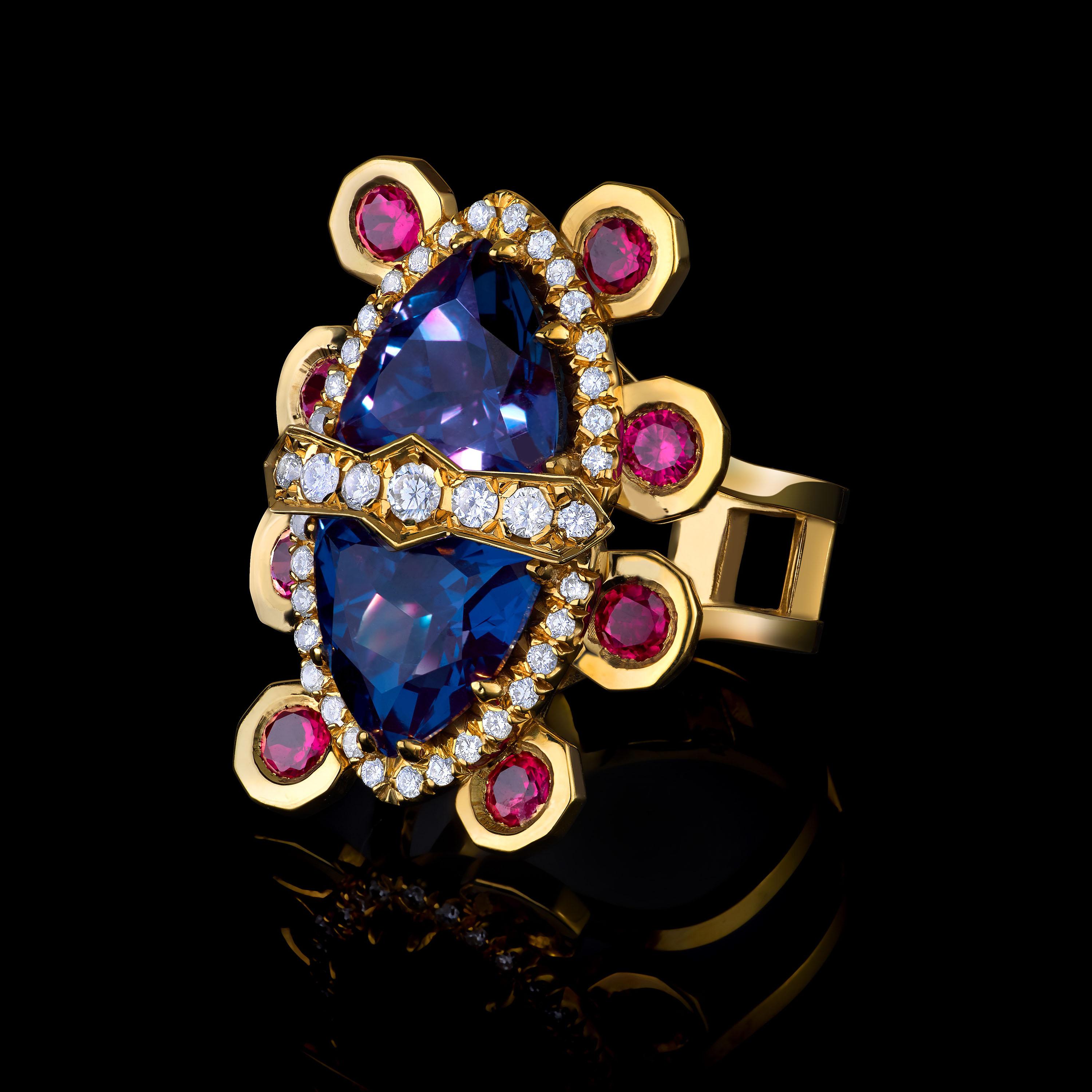 Algu ring in 18K gold featuring two colour changing Alexandrites (7.85ctw), diamonds (0.31ctw), and rubies (1.2ctw).

Algu is a Saami (Northern Swedish) word for creation. The ring is an homage to the creation myth of the Northern people of Europe.
