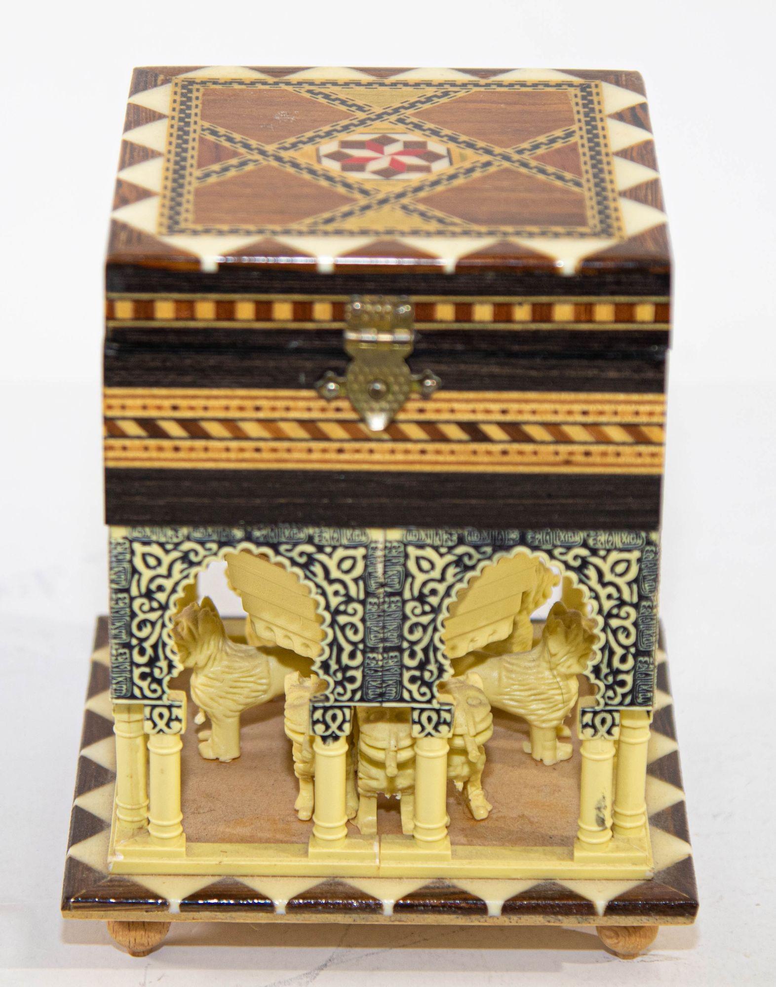 Handmade music box by Miguel Laguna, handcrafted in Granada, Spain, the box represent the Alhambra with Moorish arches, the outside is inlay with bone and marquetry, the inside is lined with red velvet.
The Moorish architectural elements are on all