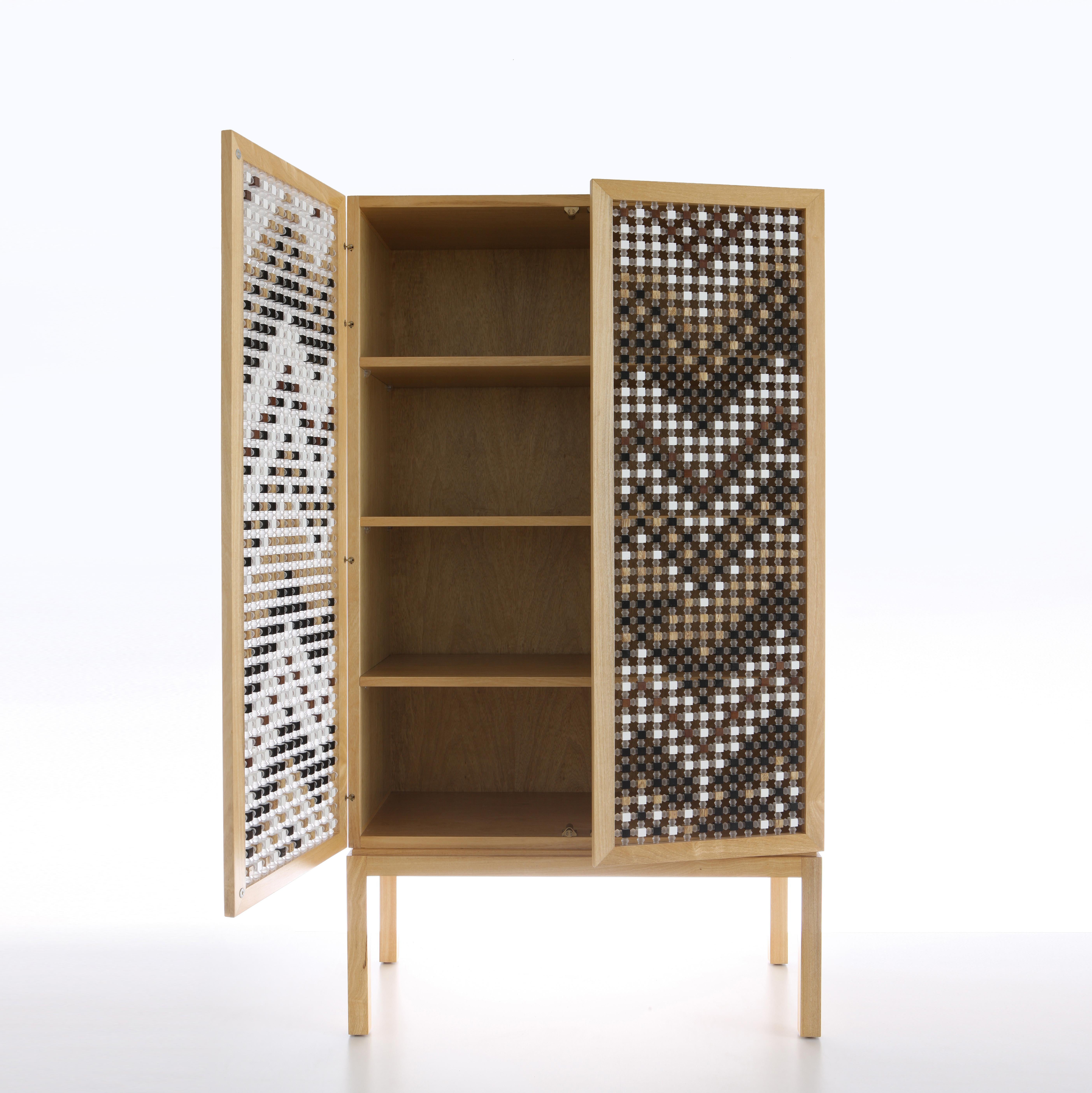 The mousharabiyeh-inspired doors of the Ali Baba cabinet are constructed with traditional technique re-appropriated in modern material, with each piece set by hand and X-ed with acrylic joints.