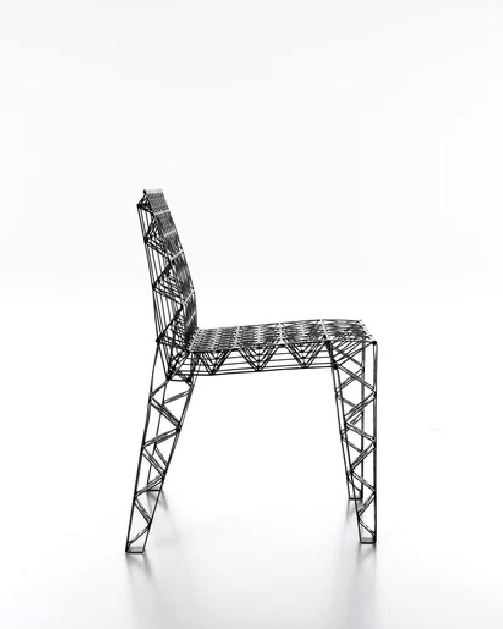 Stackable chair made entirely of aluminium through a process of laser cut, folded and riveted sheets. 
Finish poweder-coated textured black.

DIMENSION:
H 75 × D 53 × W 56 cm

Available in other various options