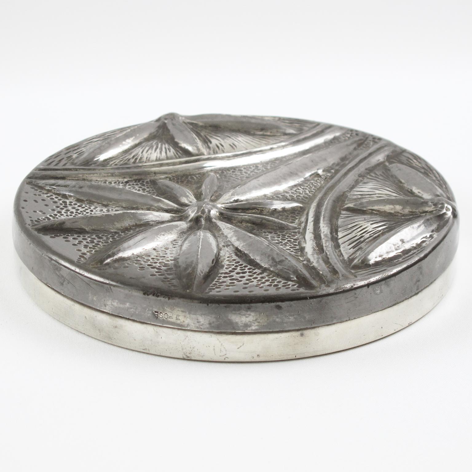 Elegant French Art Nouveau uniquely illustrated dinanderie pewter covered box by Alice Chanal (1872-1951) and Eugene Louis Chanal (1872-1925). Large hand-wrought round flat shape with typical Art Nouveau floral embossed design. Engraved signature