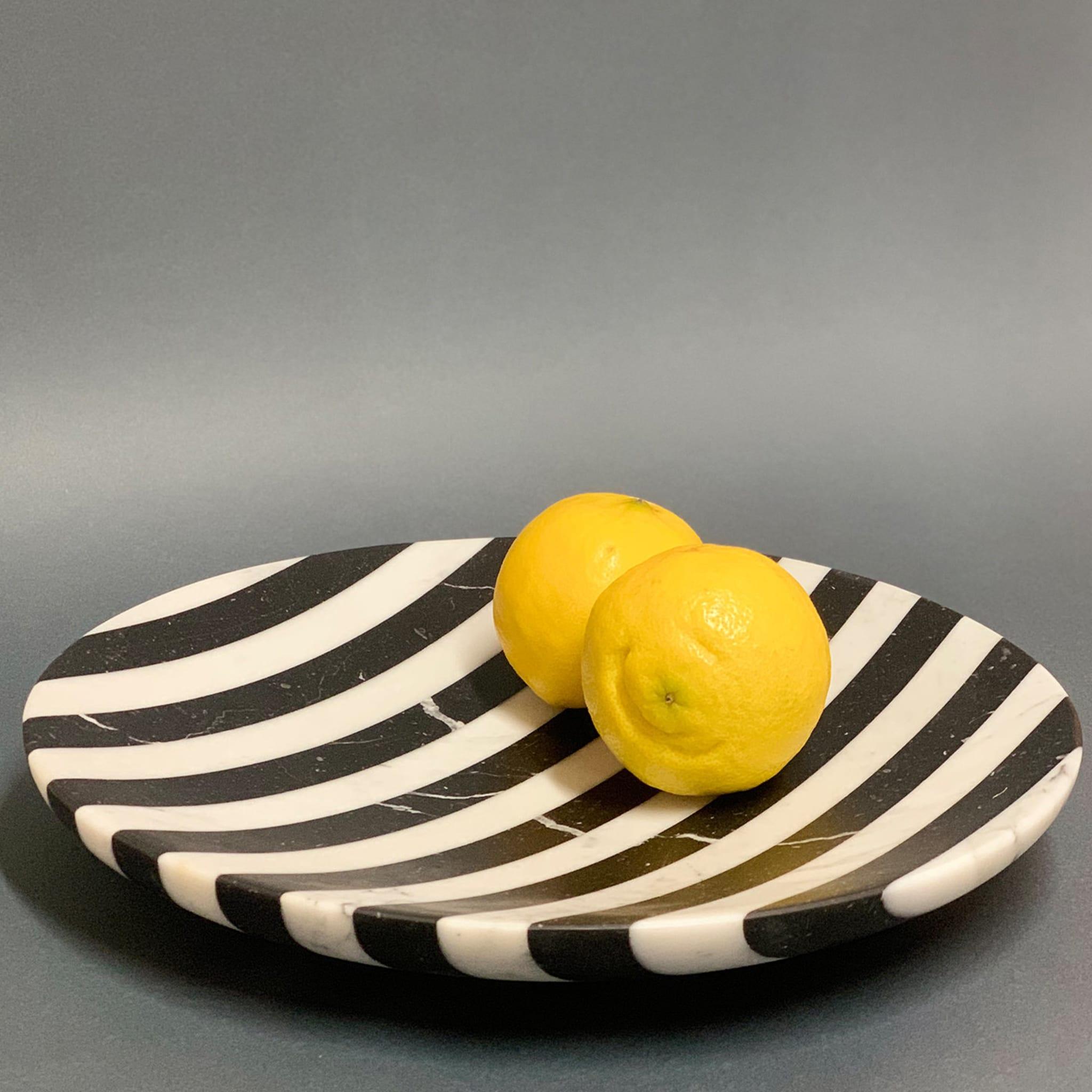 Designed by Welsh artist Bethan Gray for Editions Milano, this refined low bowl epitomizes minimalist aesthetic balance and exceptional handcraftsmanship. The low profile and delicately sloping interior are enhanced by the striped pattern created by