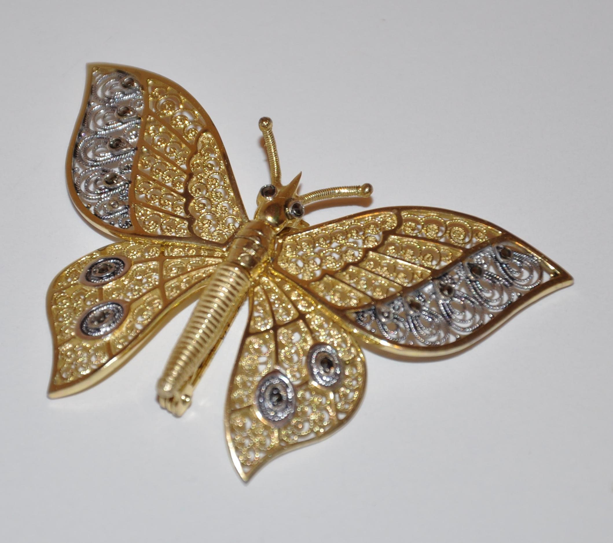        Alice Caviness wonderfully detailed sterling silver with gold overlay butterfly brooch has all four wings moveable if desired. Filigree handwork and made in Germany. The upper wings  measures 2 3/8 inches in width, with the smaller wings