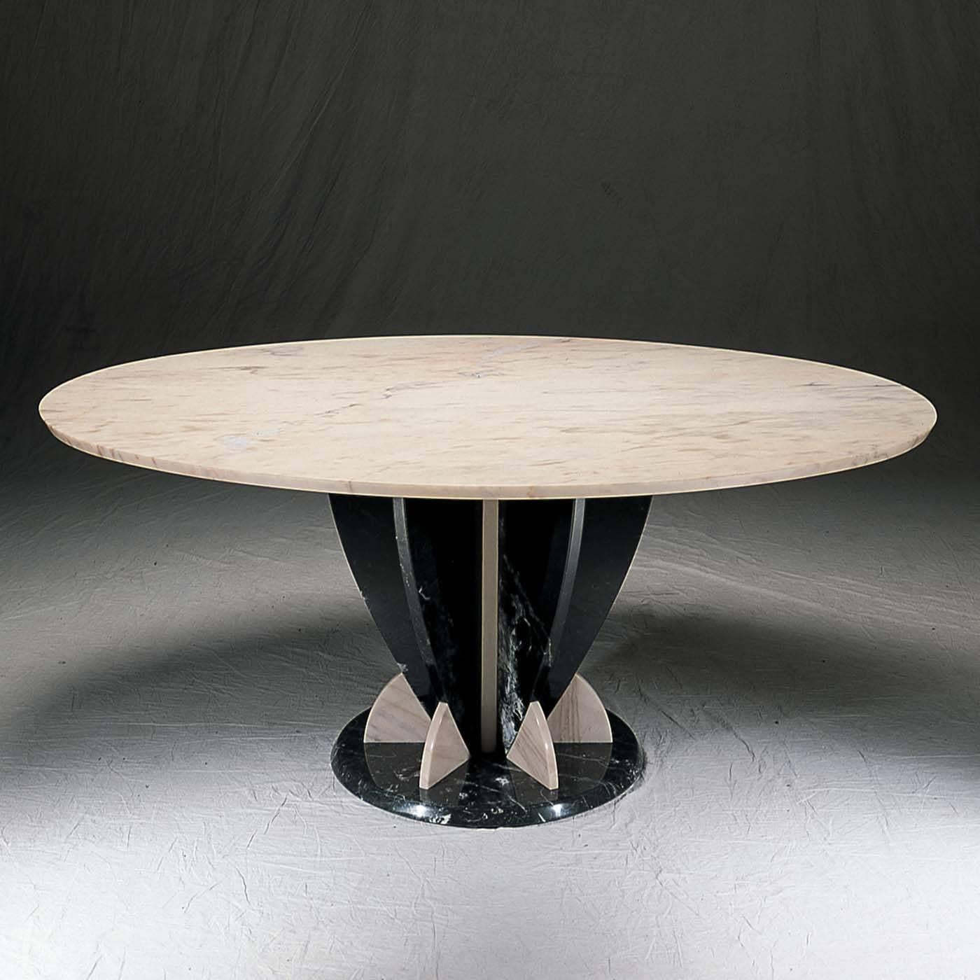 Sole protagonist of a sophisticated dining room, this table is an aesthetically stunning piece that combines the preciously elaborated base made of black Marquinia marble with a sleek, round top of pink Portogallo marble. The monolithic structure is
