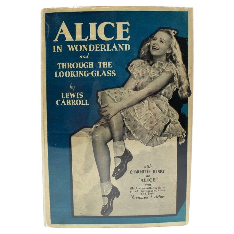 Carroll, Lewis. Alice in Wonderland and Through the Looking-Glass (Complete in One Volume). New York: Grosset & Dunlap, [n.d.] c. 1933. Octavo. In the original publisher’s dust jacket and blue cloth boards, with titles stamped in white and Alice