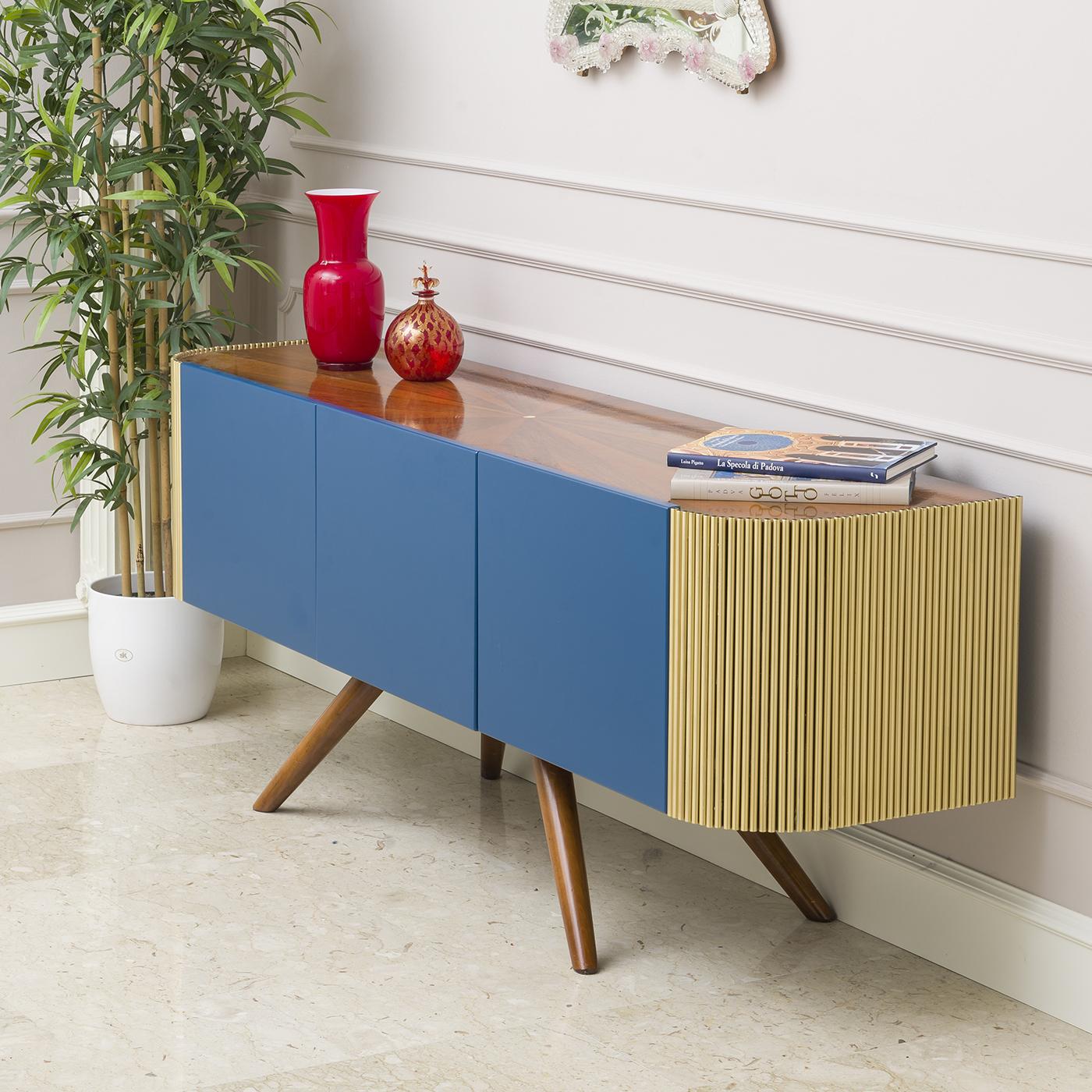 A modern and innovative designed sideboard that has a wooden body and a radial walnut top with mother of pearl carved into the center. The legs are made of walnut, while the wooden doors are lacquered blue. In contrast the sides are in brushed