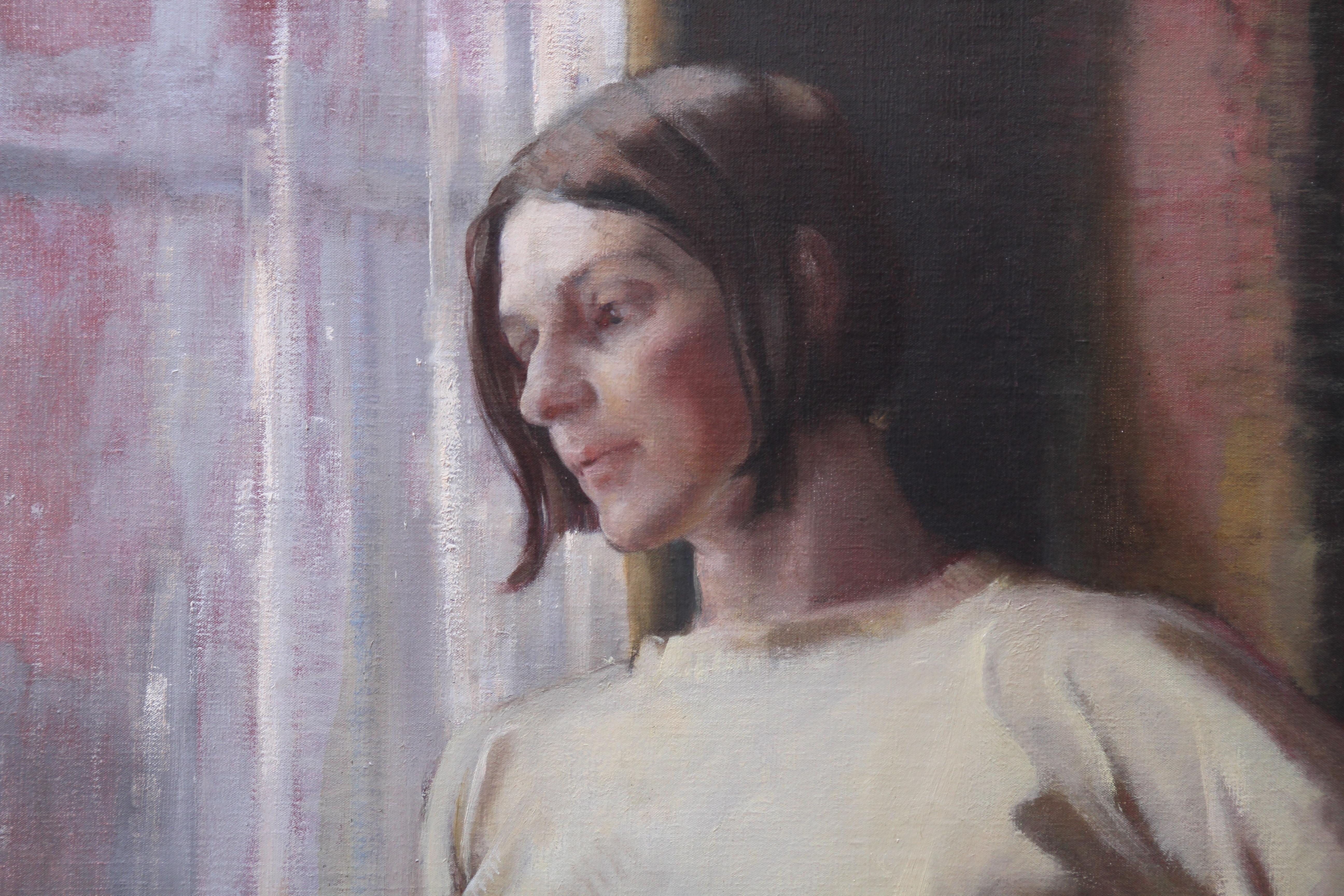 This captivating British portrait oil painting is by noted exhibited and listed female artist Alice Mary Burton. Painted circa 1955, the painting is a portrait of a woman gazing out of a window. Is she watching someone leaving or arriving or simply