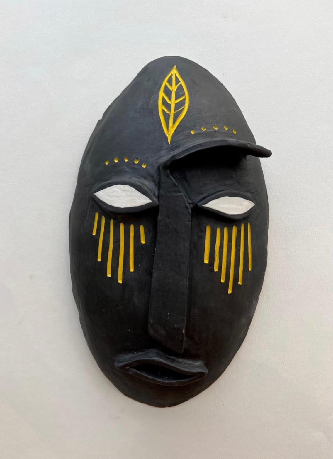 Clay abstract sculpture of a black mask with yellow lines on it. 

Unique one of a kind painting signed by the artist. 

ARTIST BIO 
Alice Mizrachi is a New York based interdisciplinary artist and educator working in the mediums of painting, murals