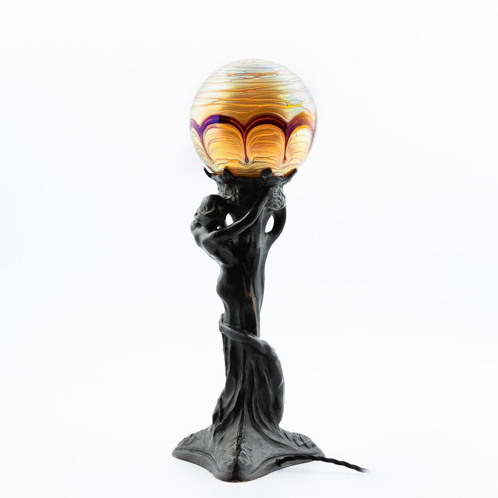 An rare Alice Nordin Art Nouveau table lamp in solid bronze, with shade in iridescent glass. Manufactured by Herman Bergman, Sweden early 1900s.

Total height 54.5cm/21.5
