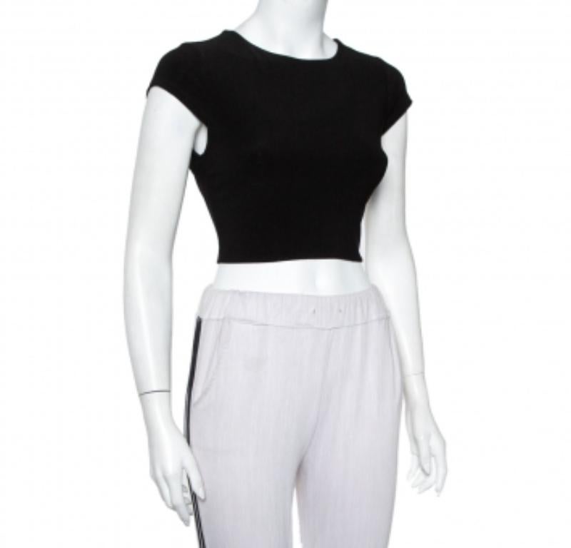 This black knit crop top from Alice + Olivia promises to add oodles of style to your wardrobe. It is made of quality materials and features a round neckline, short sleeves, and open back detailing with a zip closure. It is sure to lend you a
