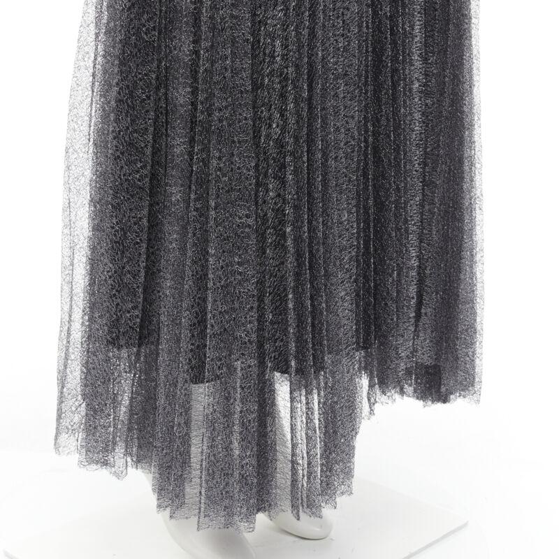 ALICE OLIVIA metallic silver thread black pleated asymmetric hem skirt US2
Reference: KNLM/A00199
Brand: Alice Olivia
Material: Nylon
Color: Silver, Black
Pattern: Solid
Closure: Zip
Lining:  Polyester
Made in: China

CONDITION:
Condition: