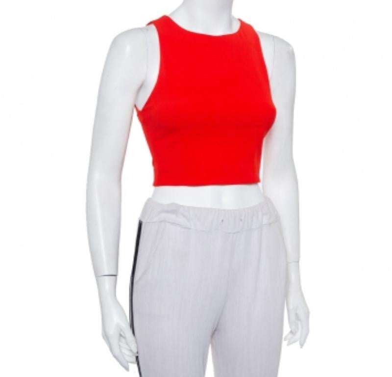 This trendy and classy top from the house of Alice + Olivia will just take your breath away! The red creation is made from crepe and features a lace trim at the back. The sleeveless cropped top flaunts a round neckline and a zip closure.