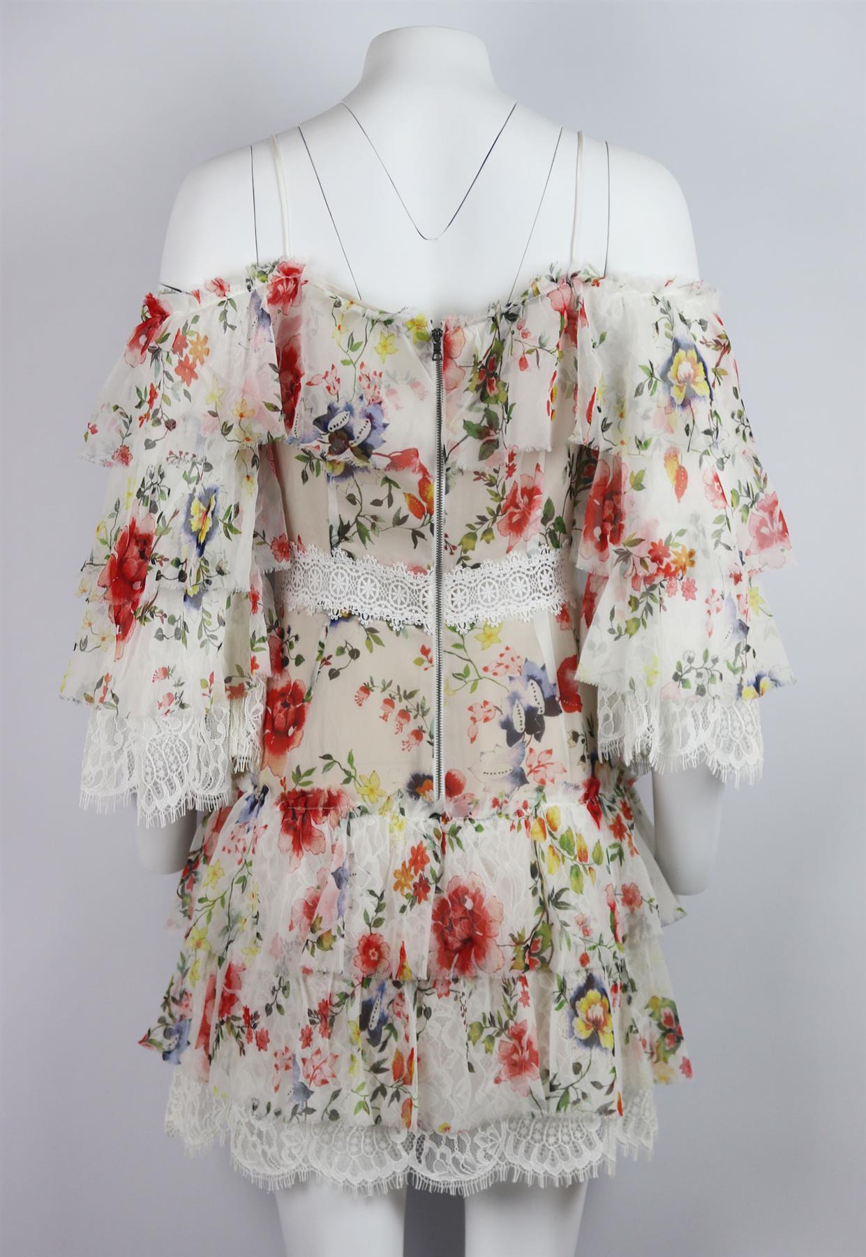 This Alice + Olivia ‘Santos’ dress has been made from airy silk-georgette digitally printed with vibrant flowers, it has a cold-shoulder silhouette that's secured by delicate straps, the white lace trims and ruffled tiers create graceful movement,