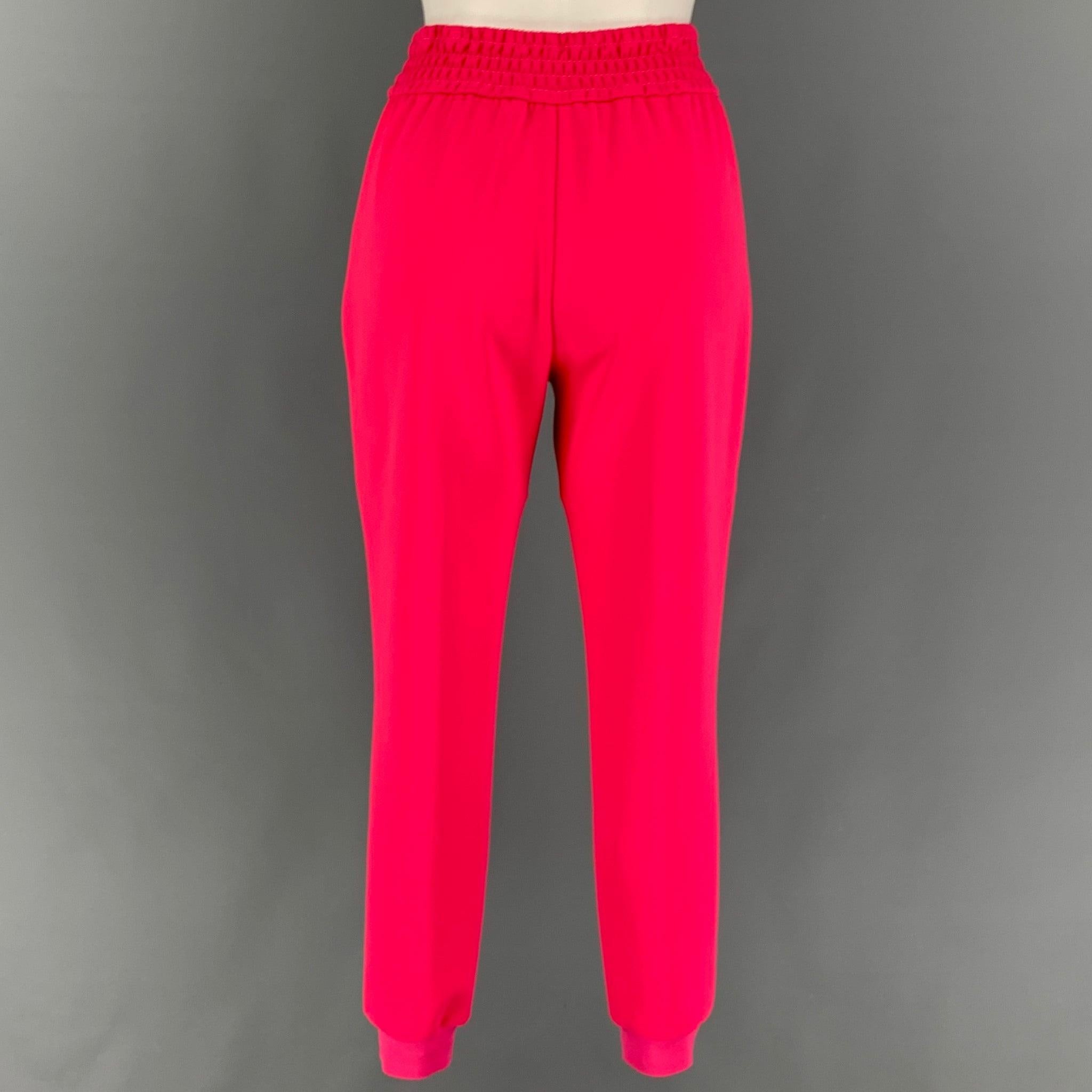 ALICE + OLIVIA pants comes in a pink polyester featuring a pleated front, jogger style, slit pockets, and a elastic waistband.
Very Good
Pre-Owned Condition. 

Marked:   4 

Measurements: 
  Waist: 24 inches  Rise: 11 inches  Inseam: 27.5 inches 
 