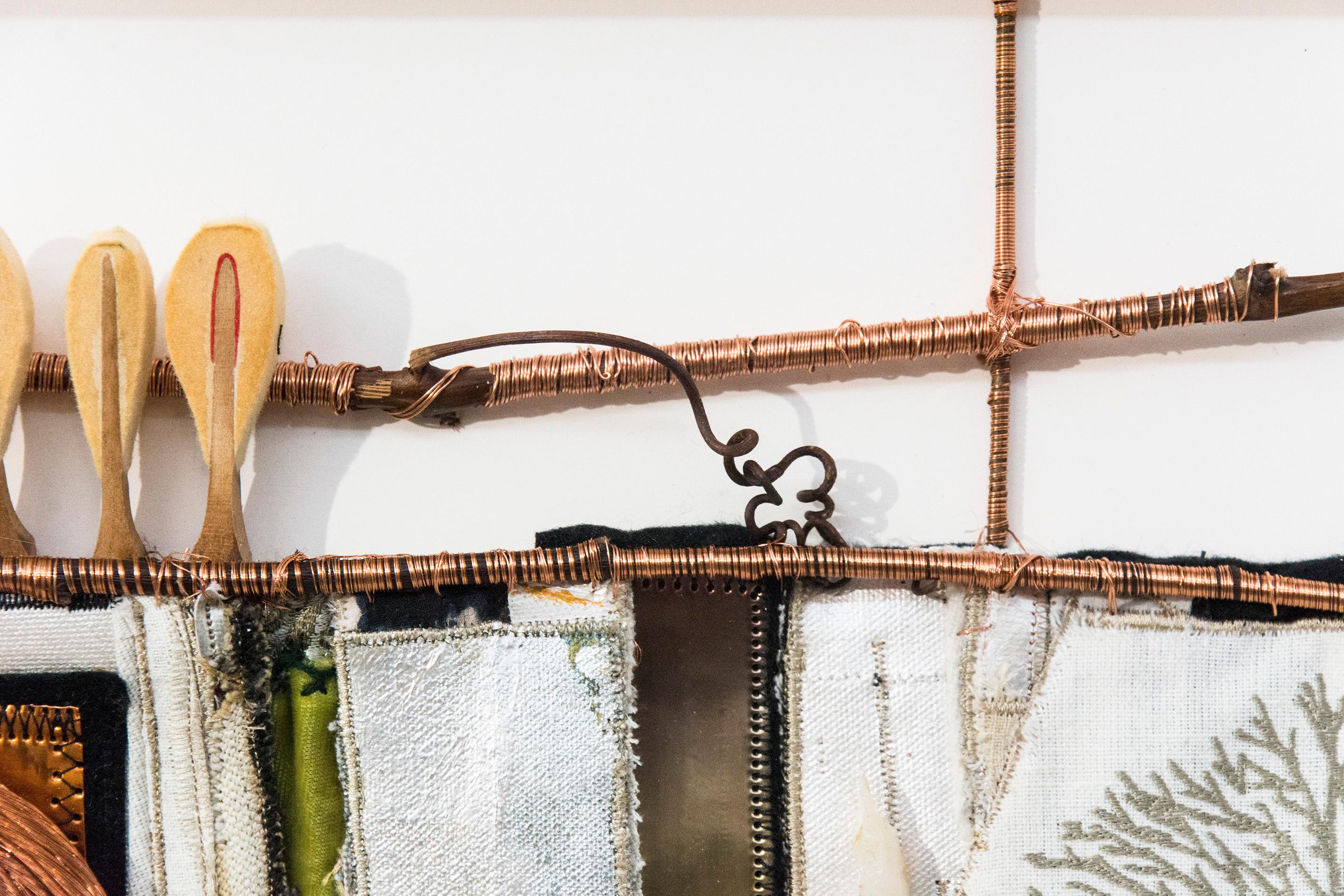 Copper sheet and wire, wood branches, embroidered fabric, metal and piano hammers are transformed into a single vessel shape with oars in this unique, horizontal wall sculpture by Canadian artist Alice Vander Vennen. The birds-eye perspective of the