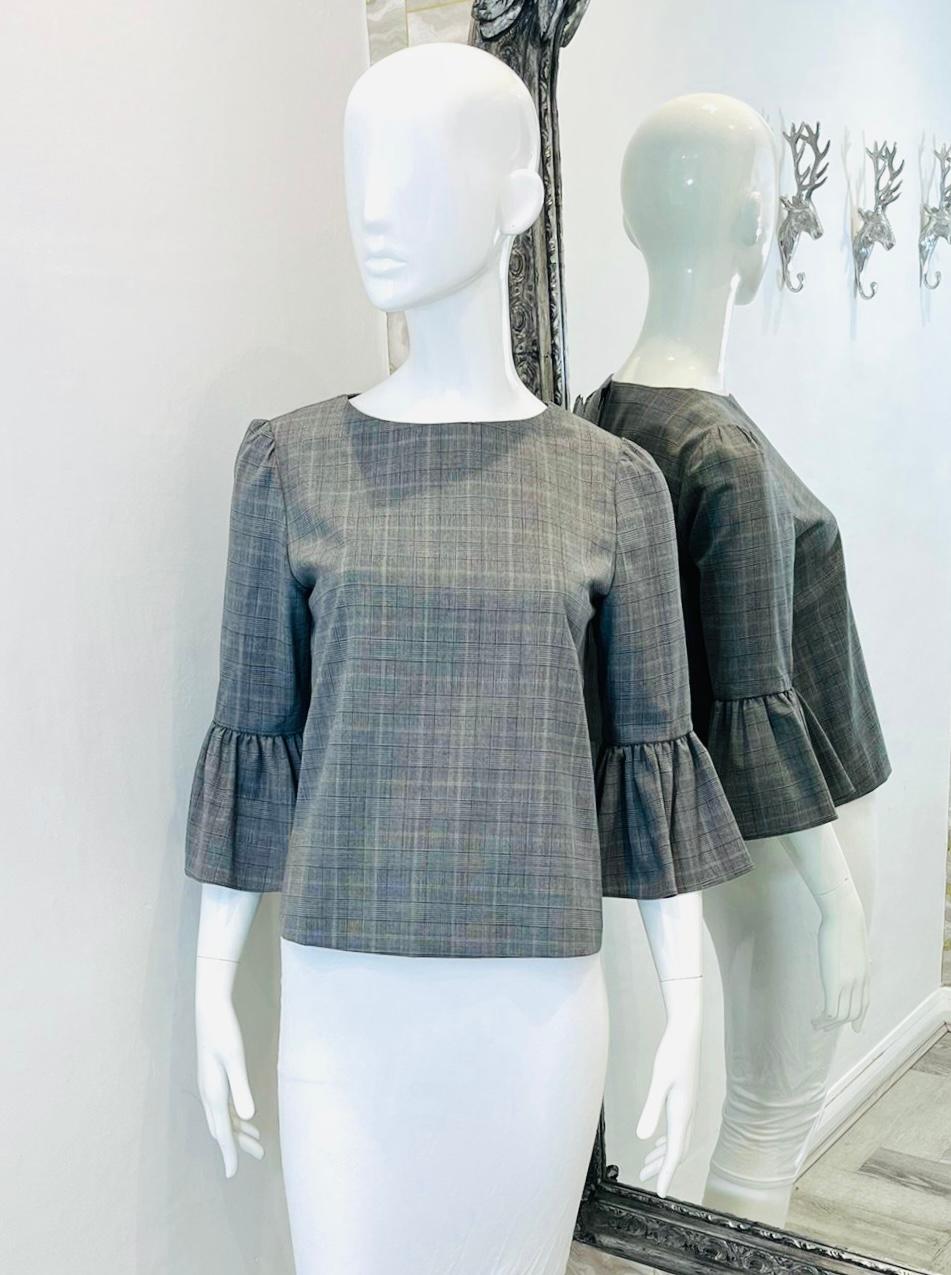 Alice+Olivia Virgin Wool Top

Grey, checked blouse designed with three-quarter flared sleeves.

Featuring round neckline and slightly cropped fit, zip closure to rear.

Size – S

Condition – Excellent

Composition – 99% Virgin Wool, 1% Elastane