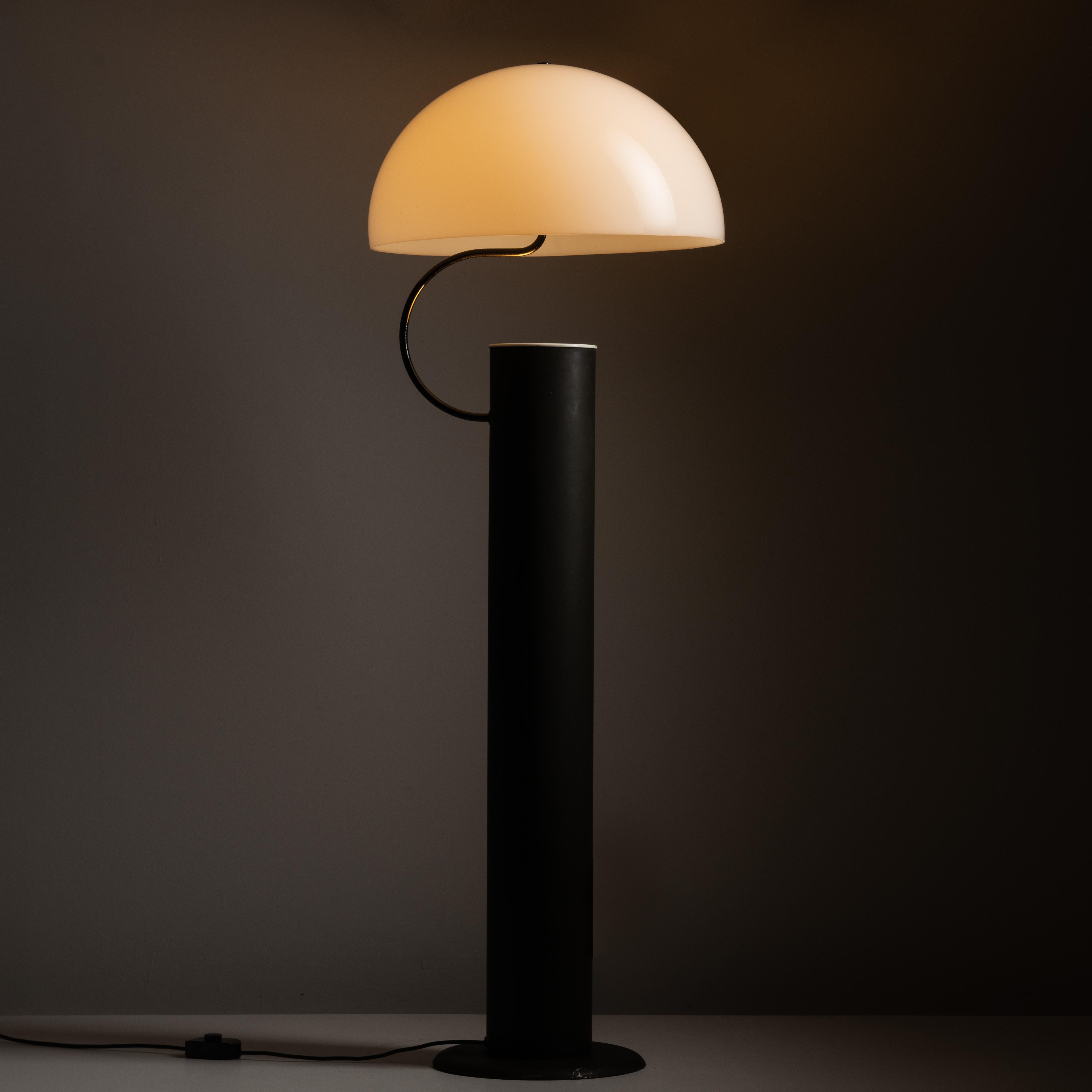 Alida floor lamp by Vico Magistretti for Oluce. Designed and manufactured in Italy, circa the 1970s. This rare model consists of an acrylic dome shade which has an illusion of floating just above a black enameled post. The shade is hoisted by a