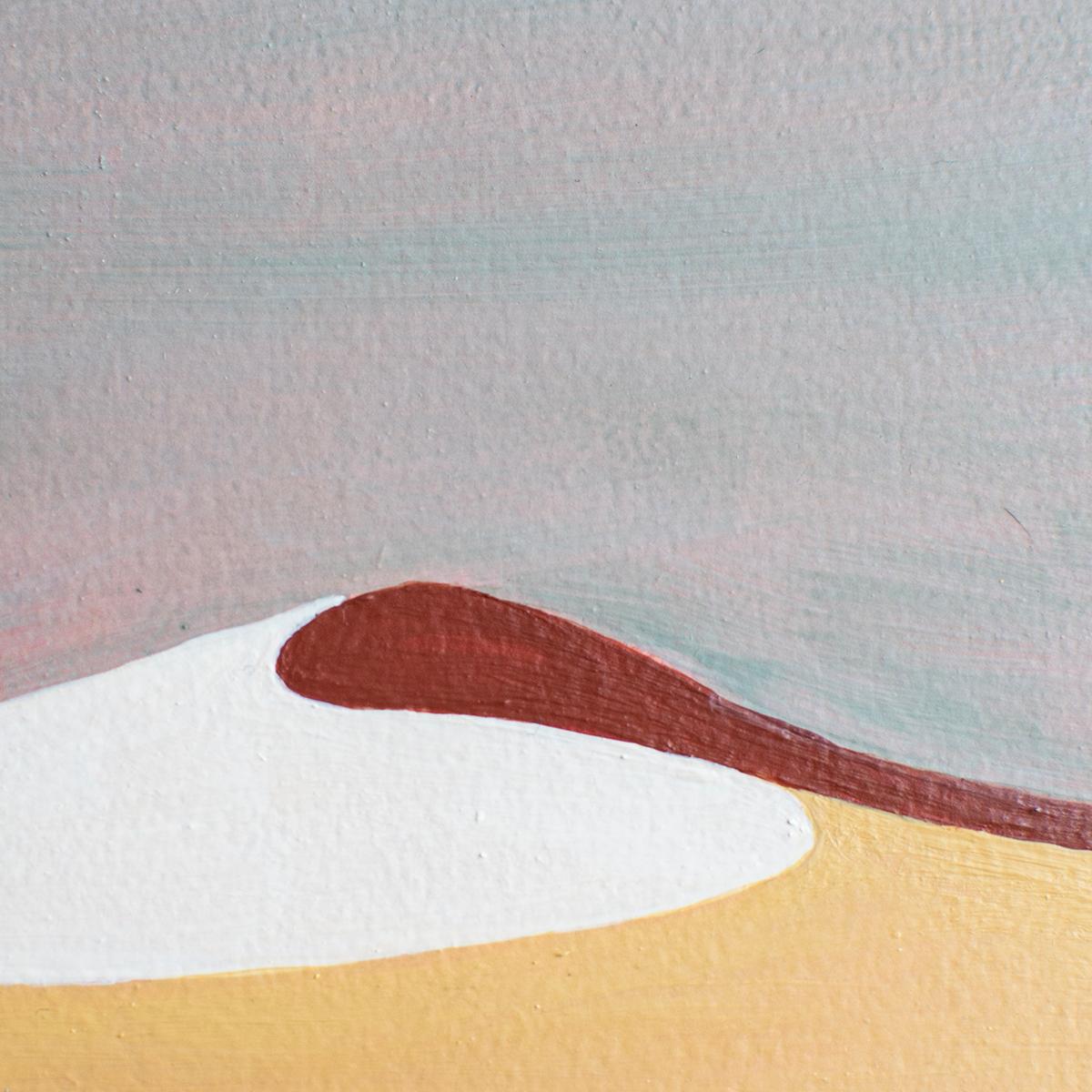 This abstract desert landscape painting by Alina B is made with acrylic paint on board. It features a unique palette with golden yellow, deep red, and white, with a sky of cool grey and muted pink layered in an almost wash overtop. The painting has
