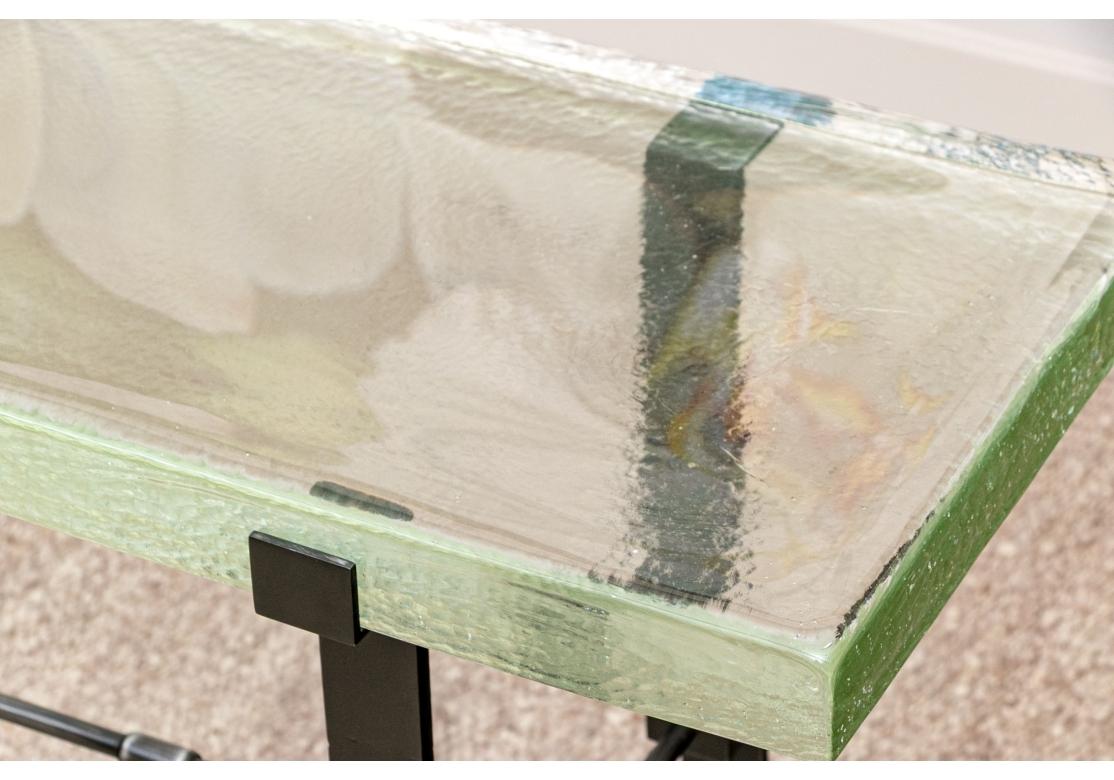 Console table designed by Alison Berger for her furniture collection. The design is inspired by everyday objects and tools of the trade, such as carpentry, metalsmithing, and jewelry making. The console features a cast glass slab top with textured