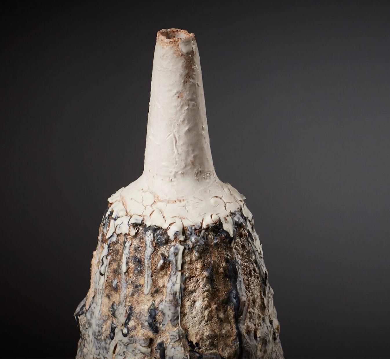 This sculpted Bottleis a decorative ceramic piece with a volcanic glaze and iron spangles, crafted by ceramicist Alison Lousada. Alison's raw yet elegant vessels are inspired by her love of Japanese and African ceramics, Icelandic landscapes and