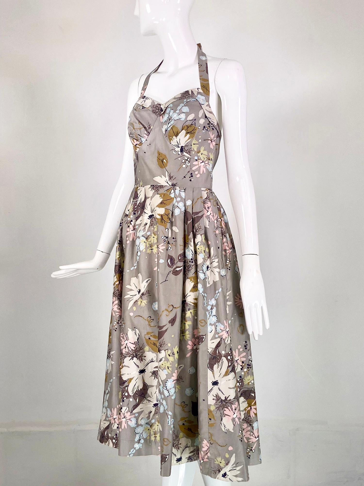 Alex of Miami halter neck modernist print sun dress from the 1950s. Florals with gold hearts cotton modernist print in grey, pink, gold, white and pale blue. Halter neck with sweetheart neckline, the neck strap closes at the back with two pink and