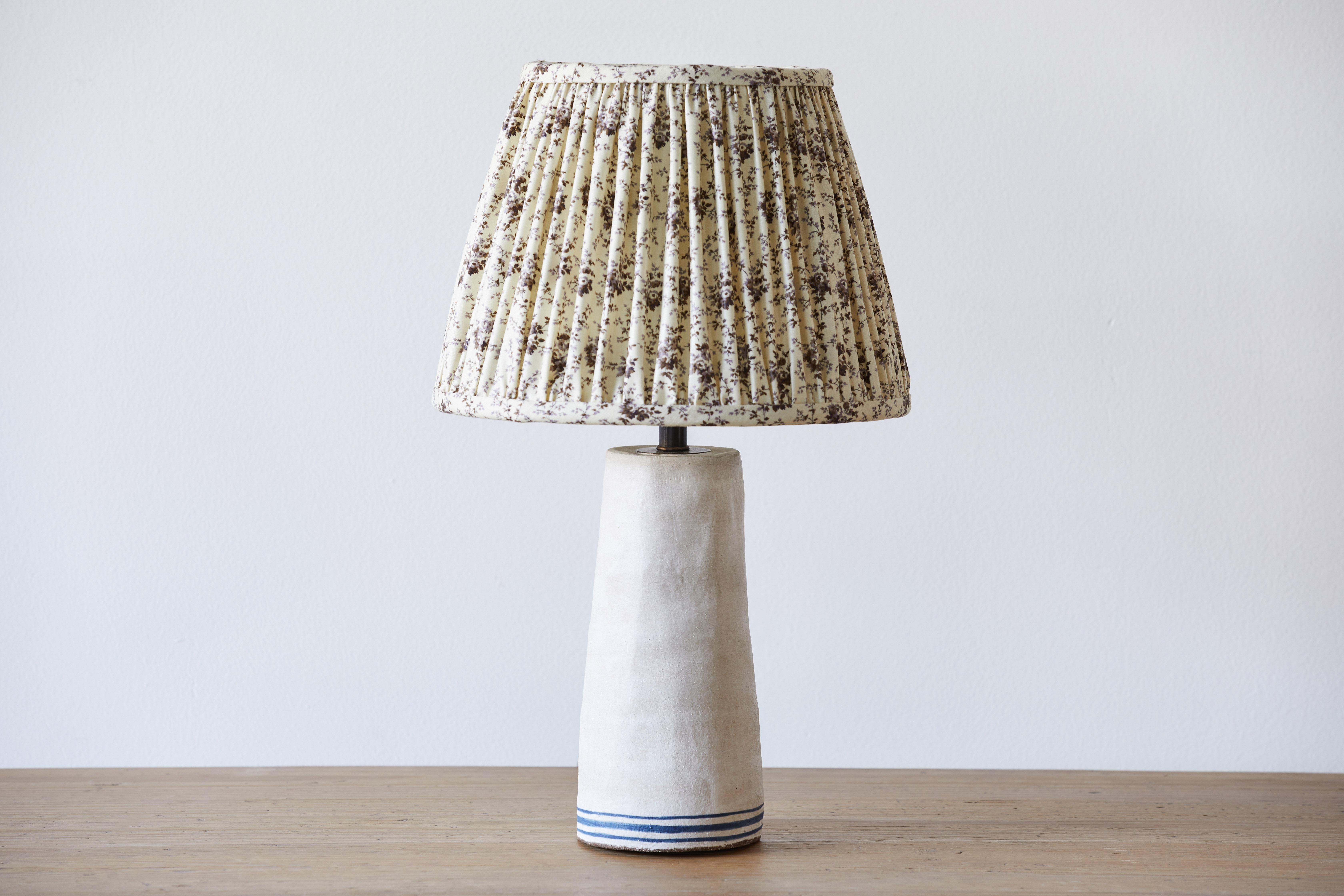 Alix Soubiran Palo table lamp with a custom shirred lampshade with Howe 36 Bourne Street Thimble print fabric.

Handmade ceramic lamp bases by the French American artist Alix Soubiran. The lamps come with brown twist cord.