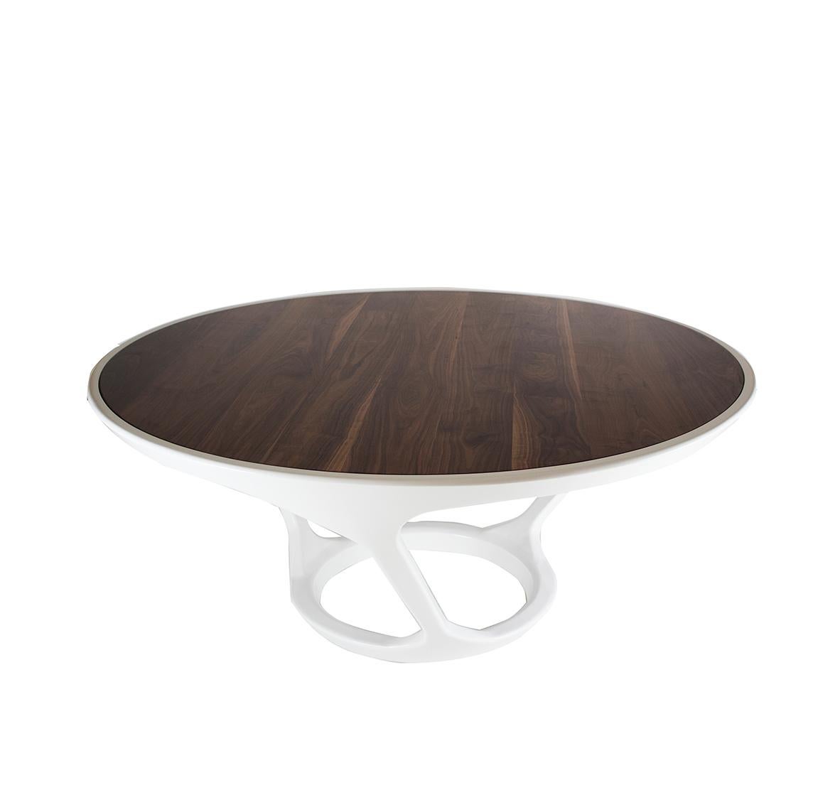 This modern round dining table has a 6 foot round maple base lacquered white and walnut top. Sits many people for easy conversations with a modern and innovative design. Customization of size and finish is available upon request.

Measurements: 30