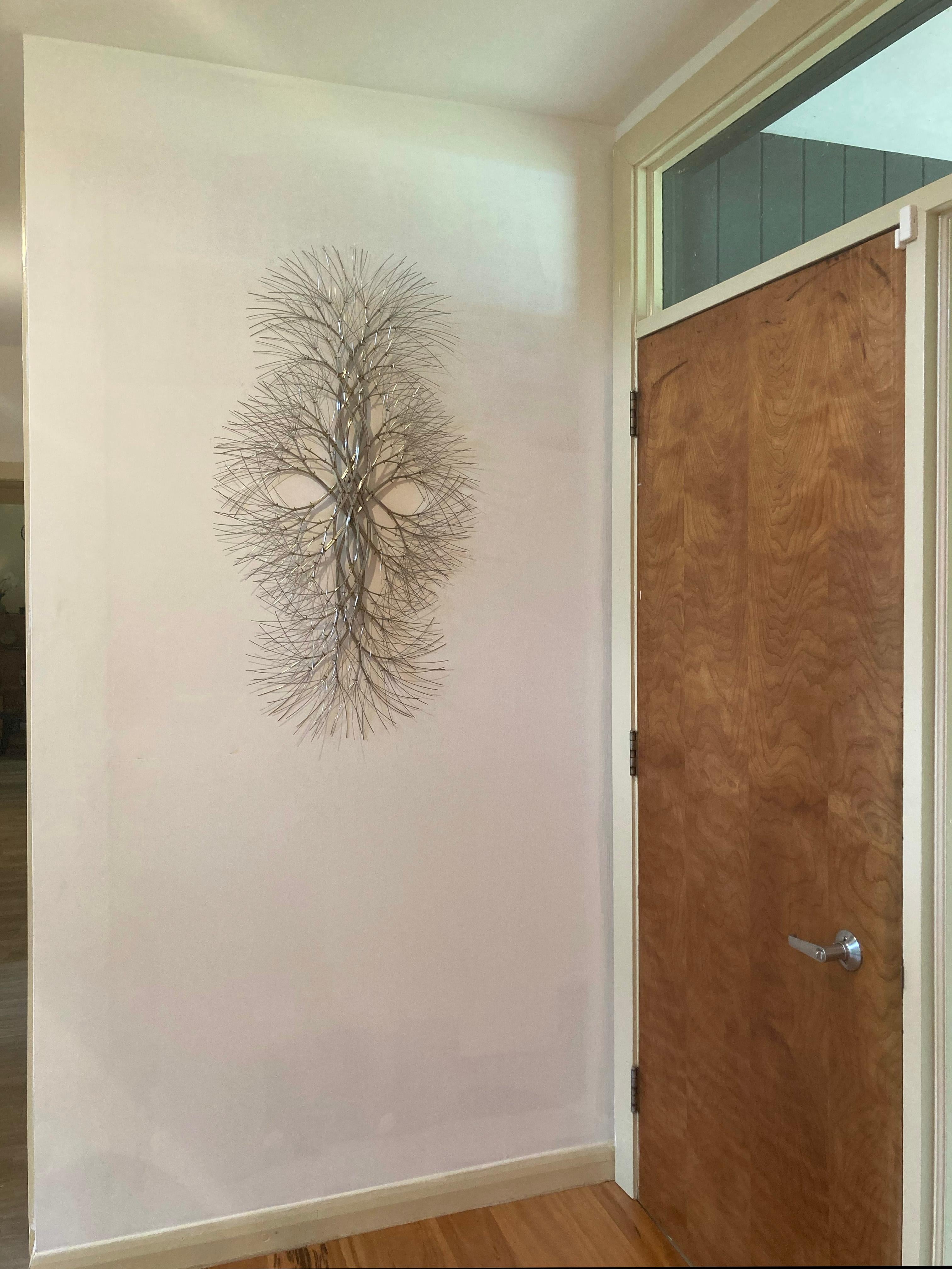 This wall sculpture is a study in natural forms, reflection, and movement. By artist Kue King. 

Search 