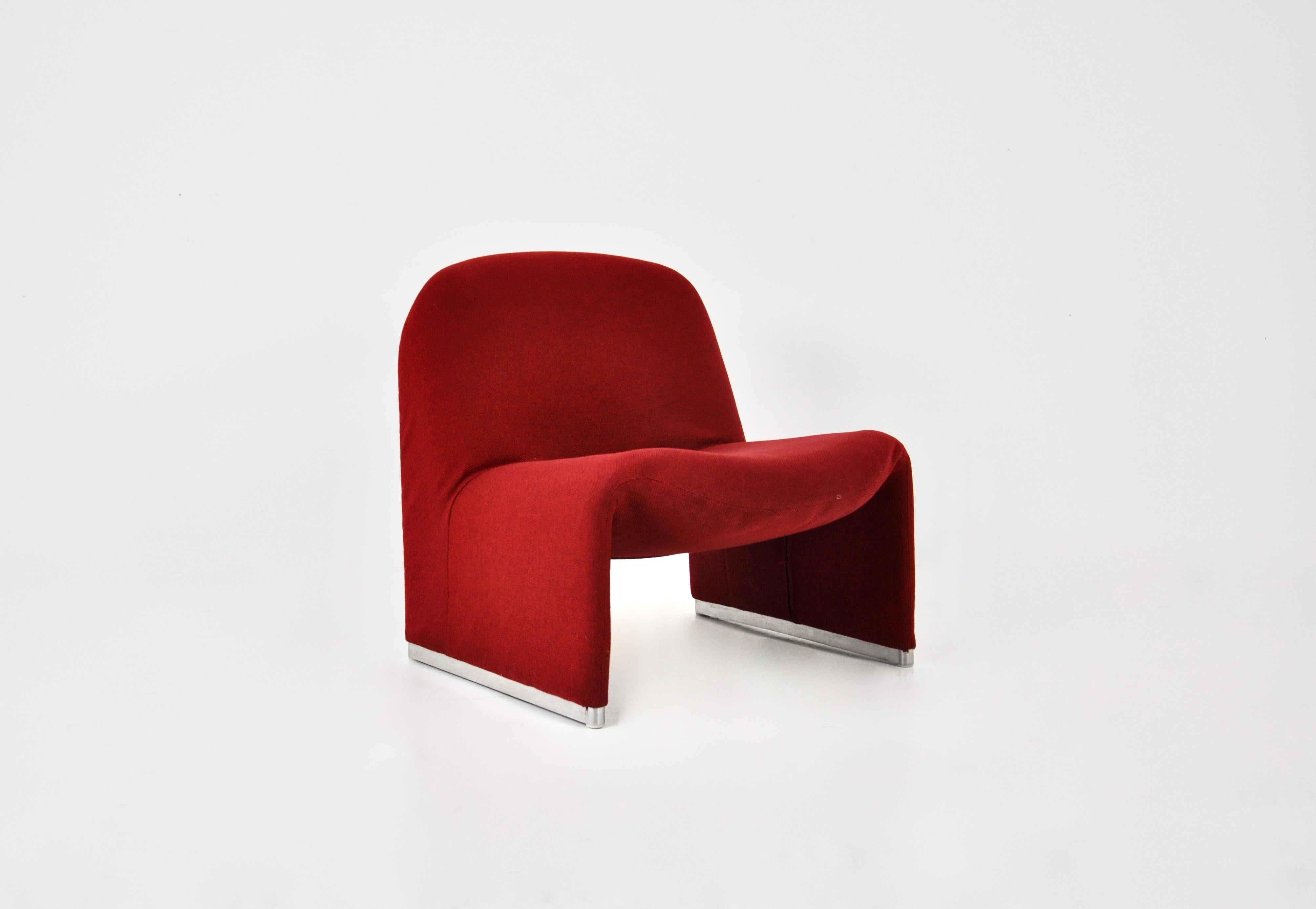 Armchair in red fabric.  Model: Alky by Giancarlo Piretti. Seat height: 40 cm. Wear due to time and age.