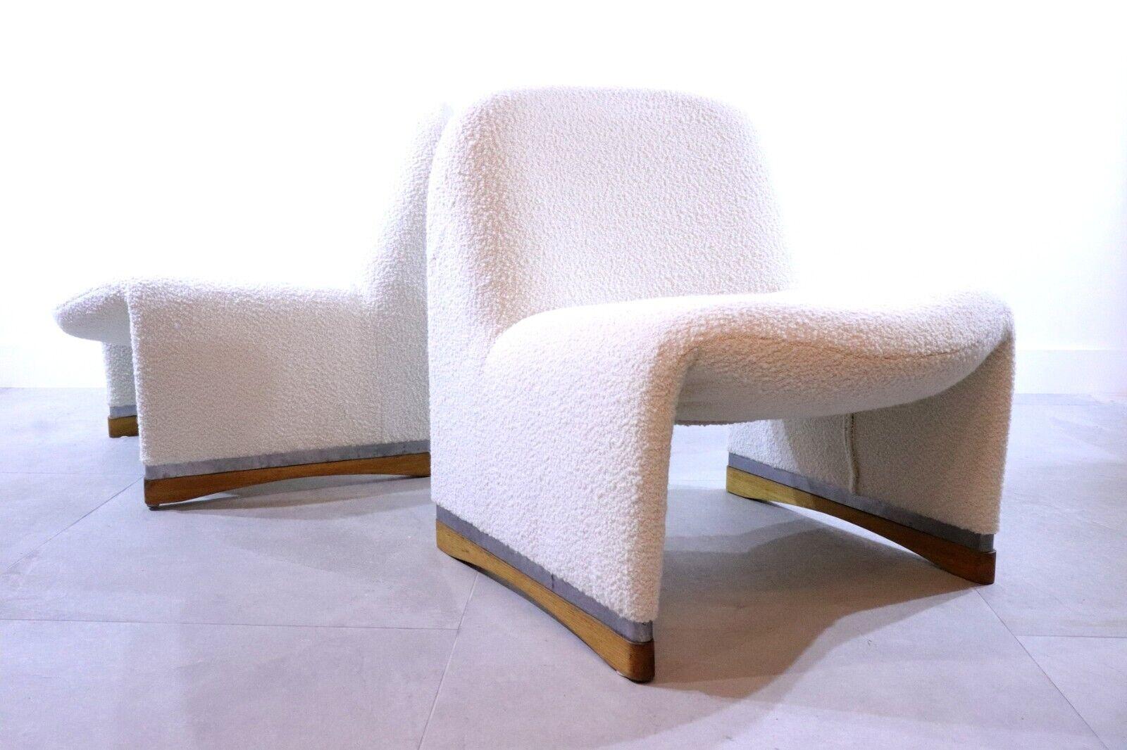 This pair of italian armchairs are a modern take on classical furnishings. designed by Giancarlo Piretti for Anonima Castelli with ergonomic forms, these chairs have a rare wooden base, where the majority of the Alky chairs are metal. The chairs