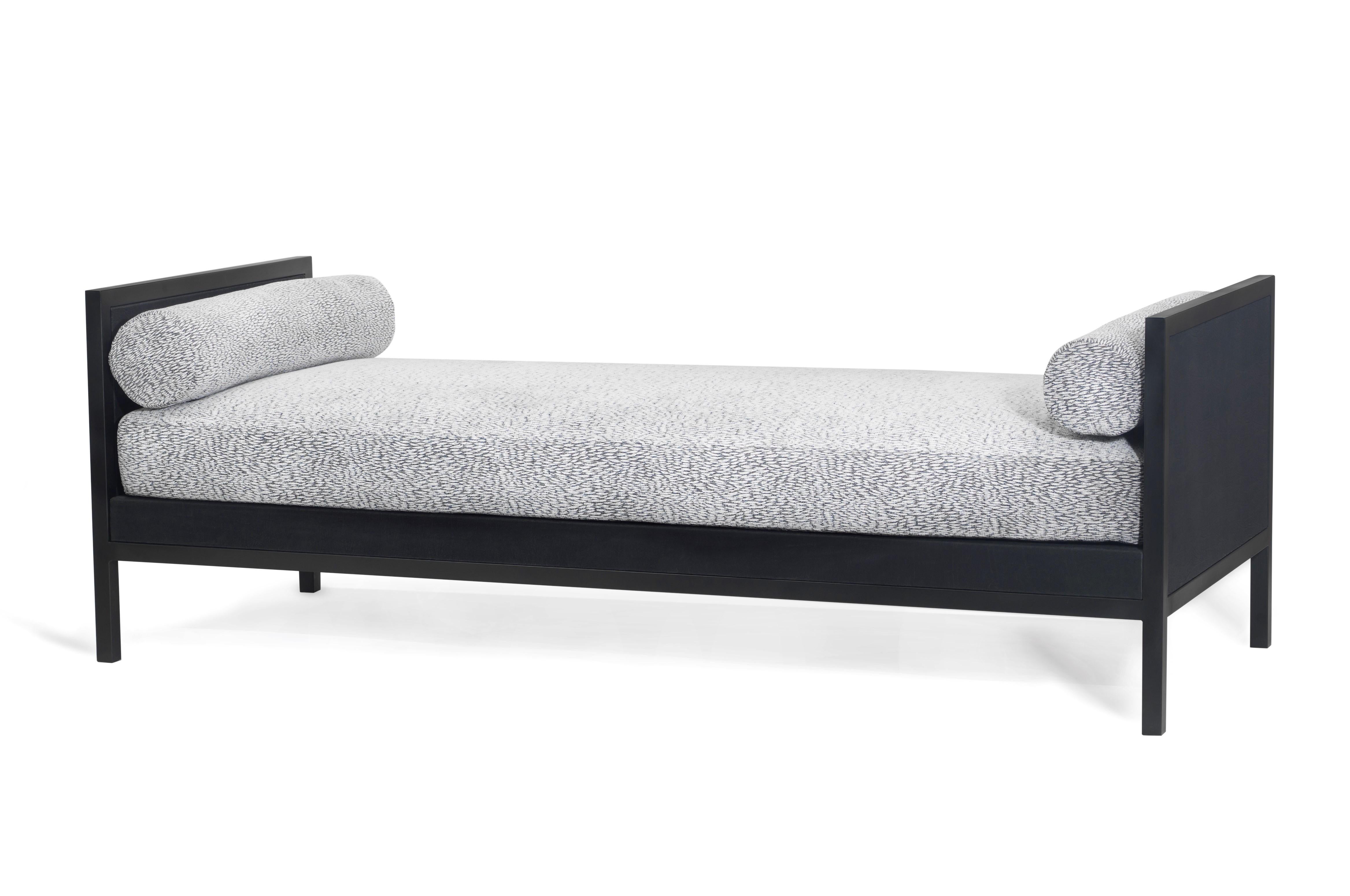 The Minimalist design of the All daybed emphasizes its comfort and simplicity. The mix of materials of its structure, available in black lacquered iron and black oak or in black lacquered iron and black embossed leather, is elevated by the use of