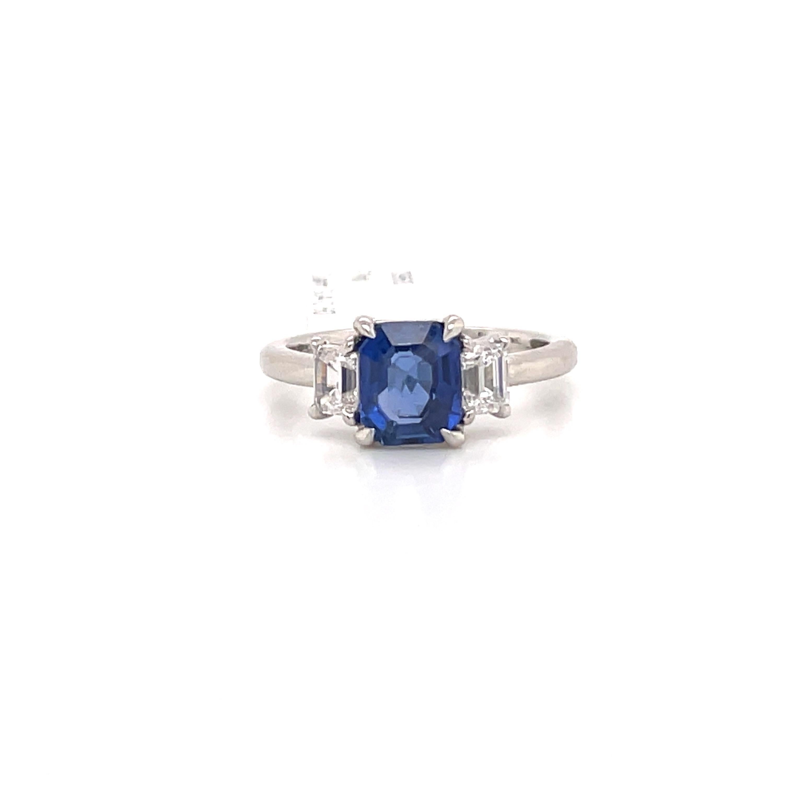 All GIA Certified three stone ring featuring one center Radiant cut Sapphire weighing 1.85 carats flanked with two Emerald cut diamonds weighing 0.60 carats.
Diamonds are GIA Certified D-F VS1